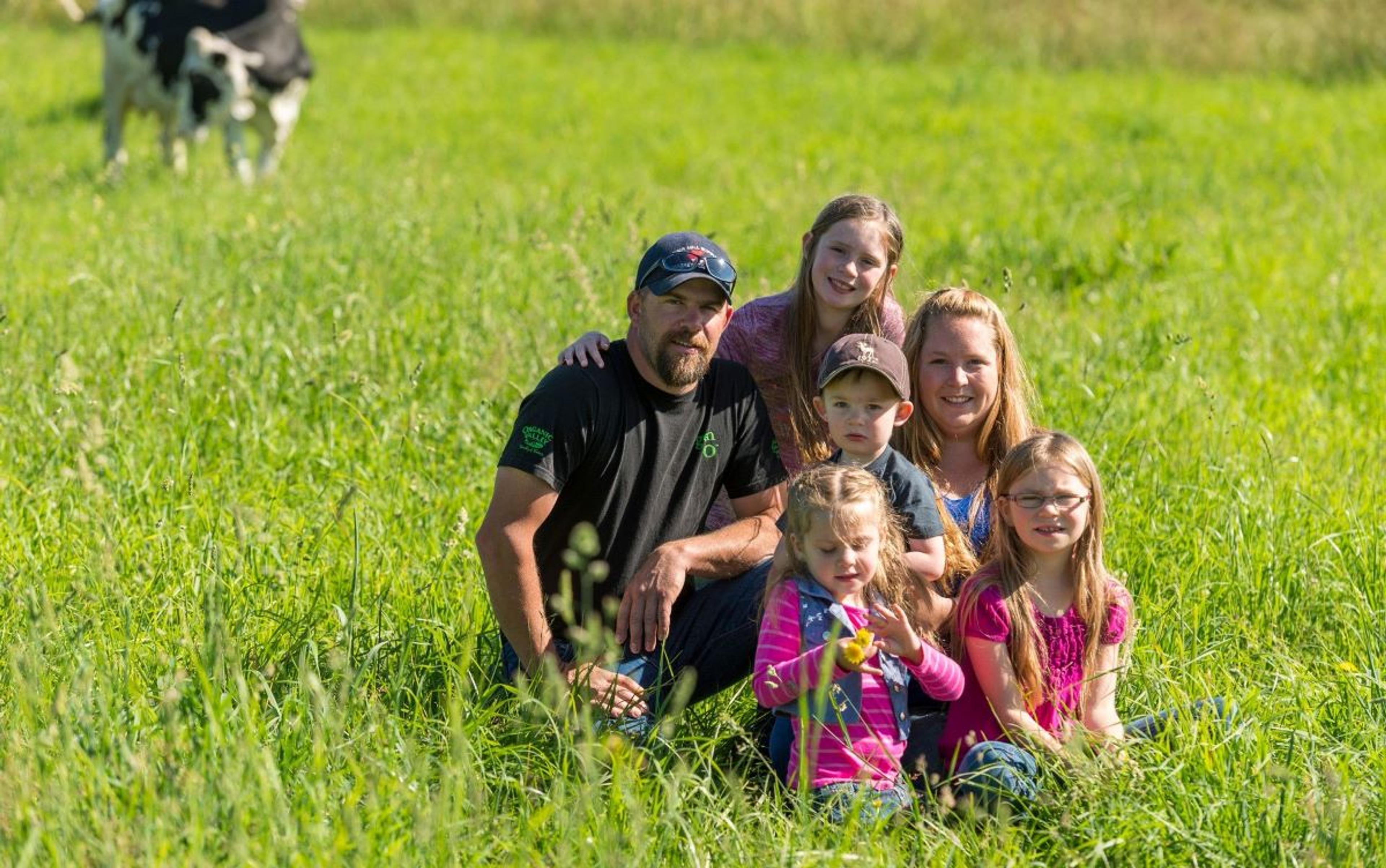 The Collman family stops for a photo in a field.