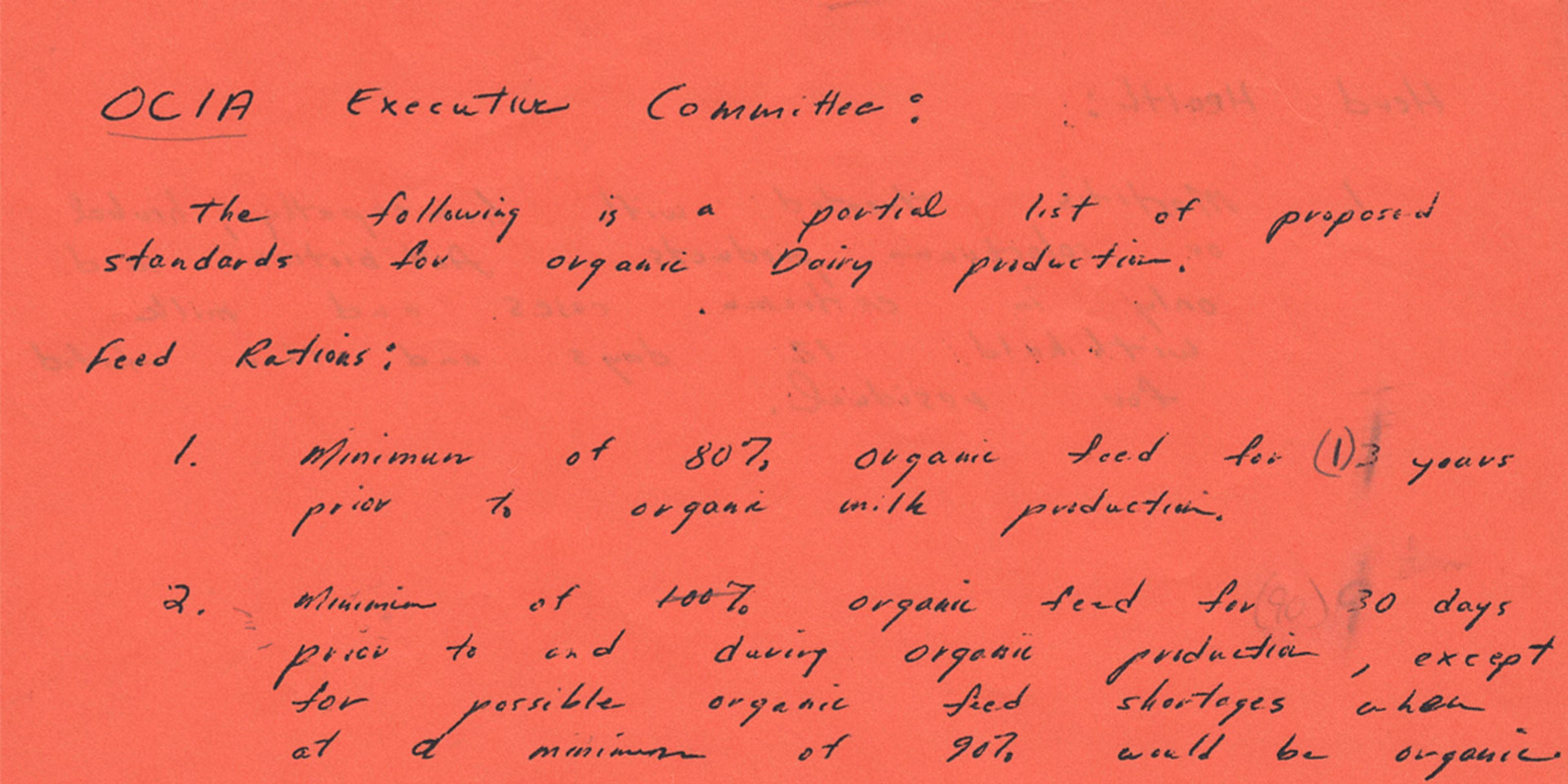 A snippet from an early draft of organic standards handwritten on orange paper.
