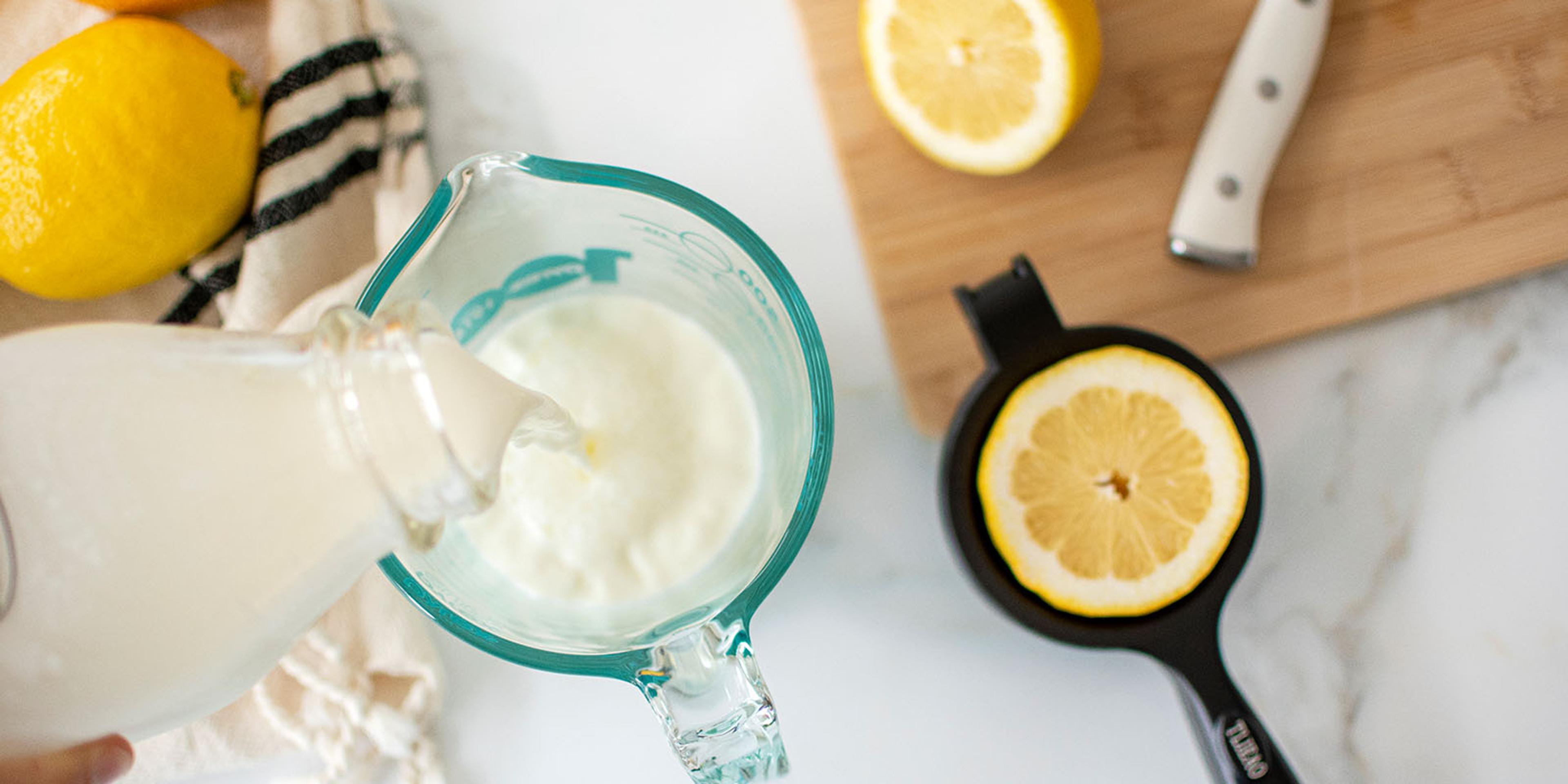 Milk and lemon are measured to make buttermilk.