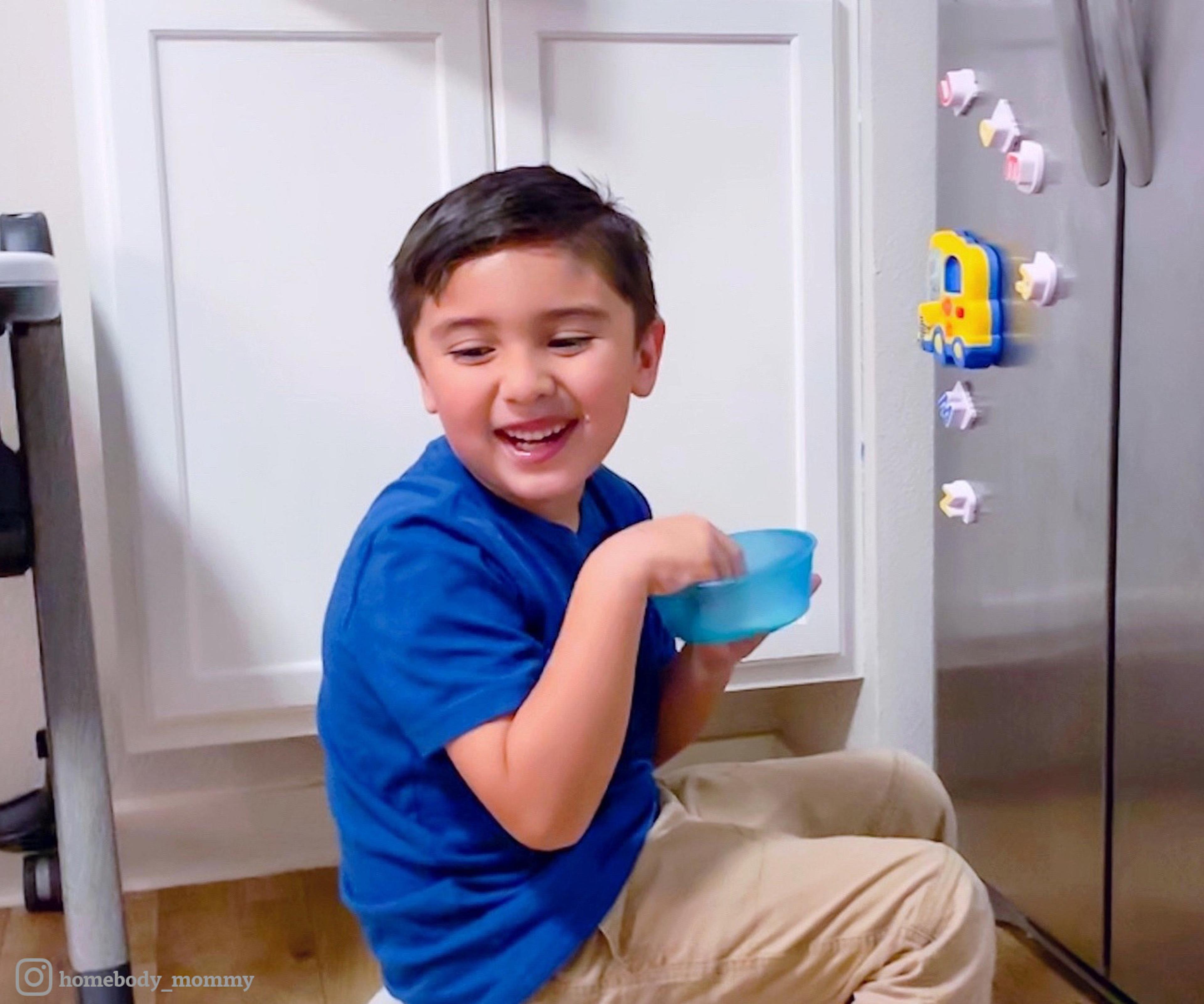 Young boy holds a bowl of cereal. Photo contribute by @homebody_mommy.