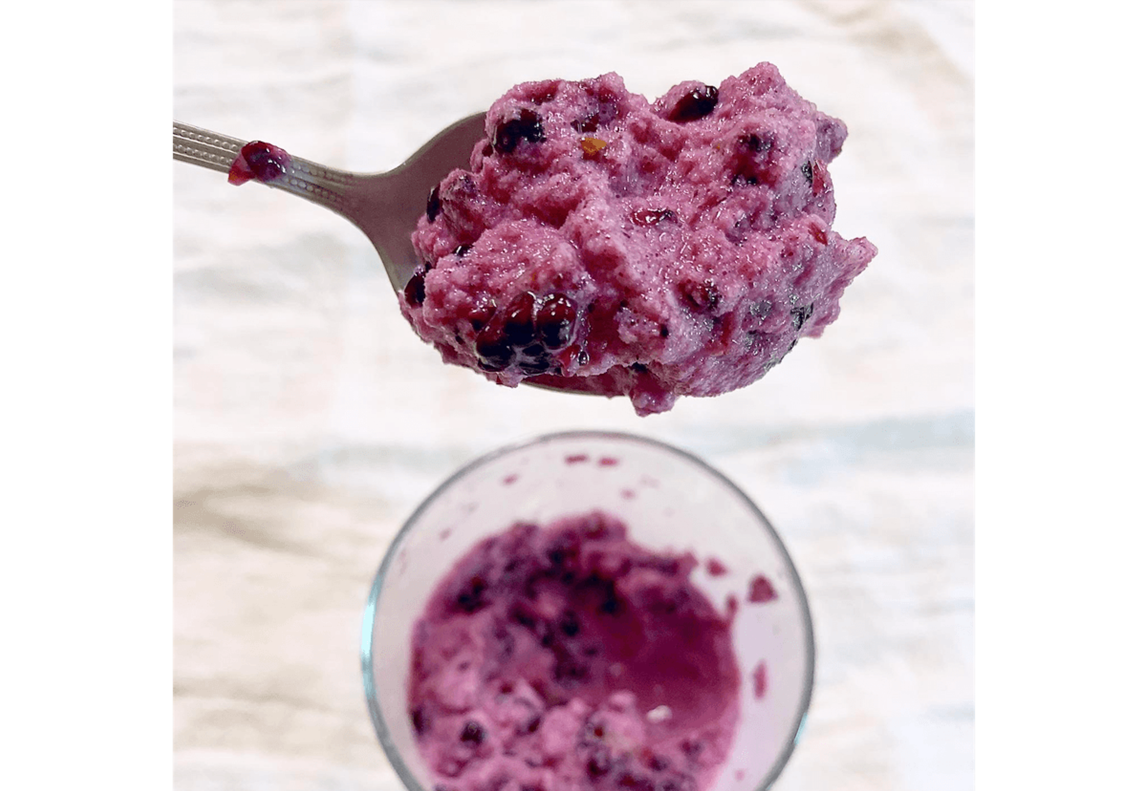 A spoonful of purple ice cream made from stirring blackberries and milk together.