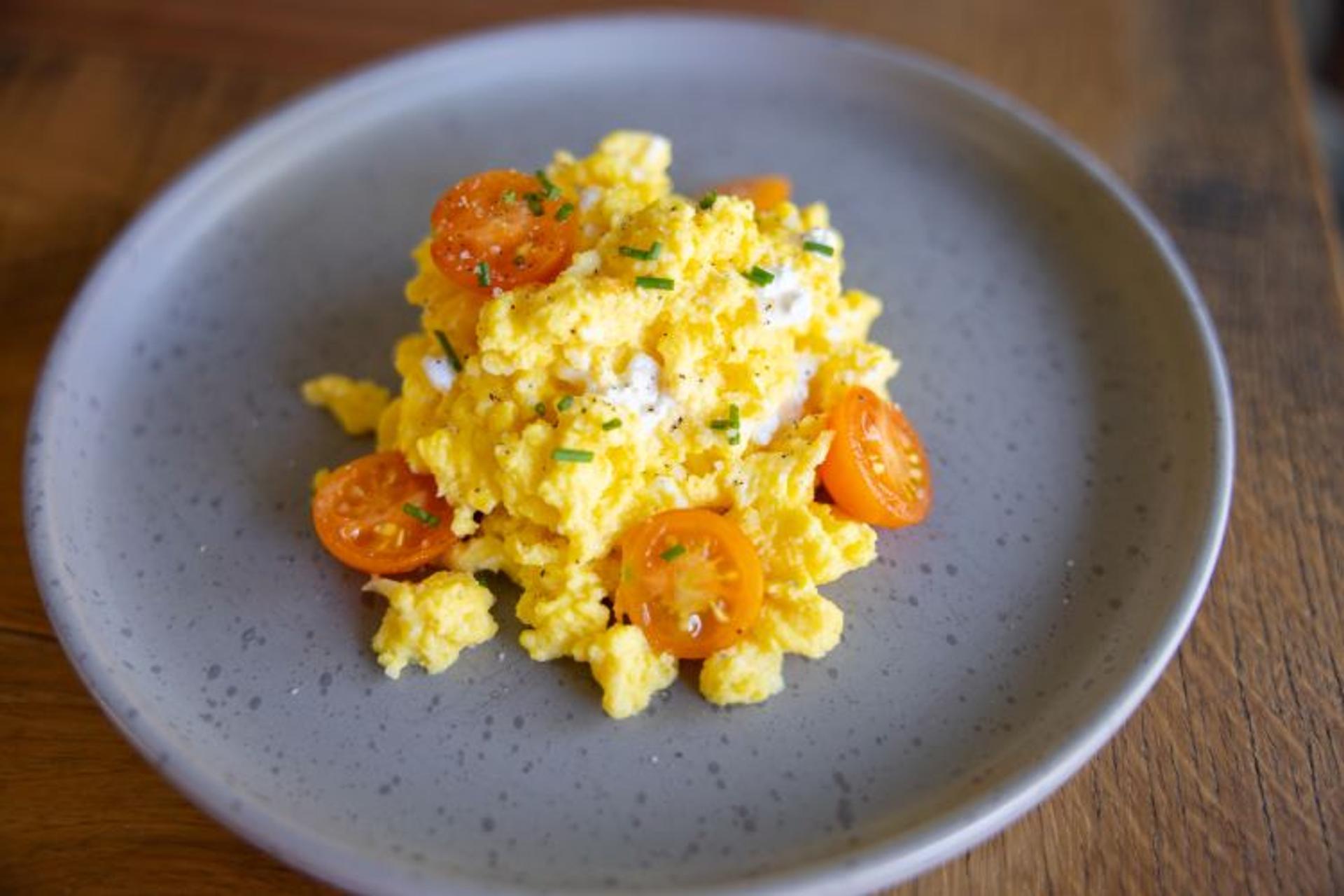 Scrambled eggs with cottage cheese and cherry tomatoes.