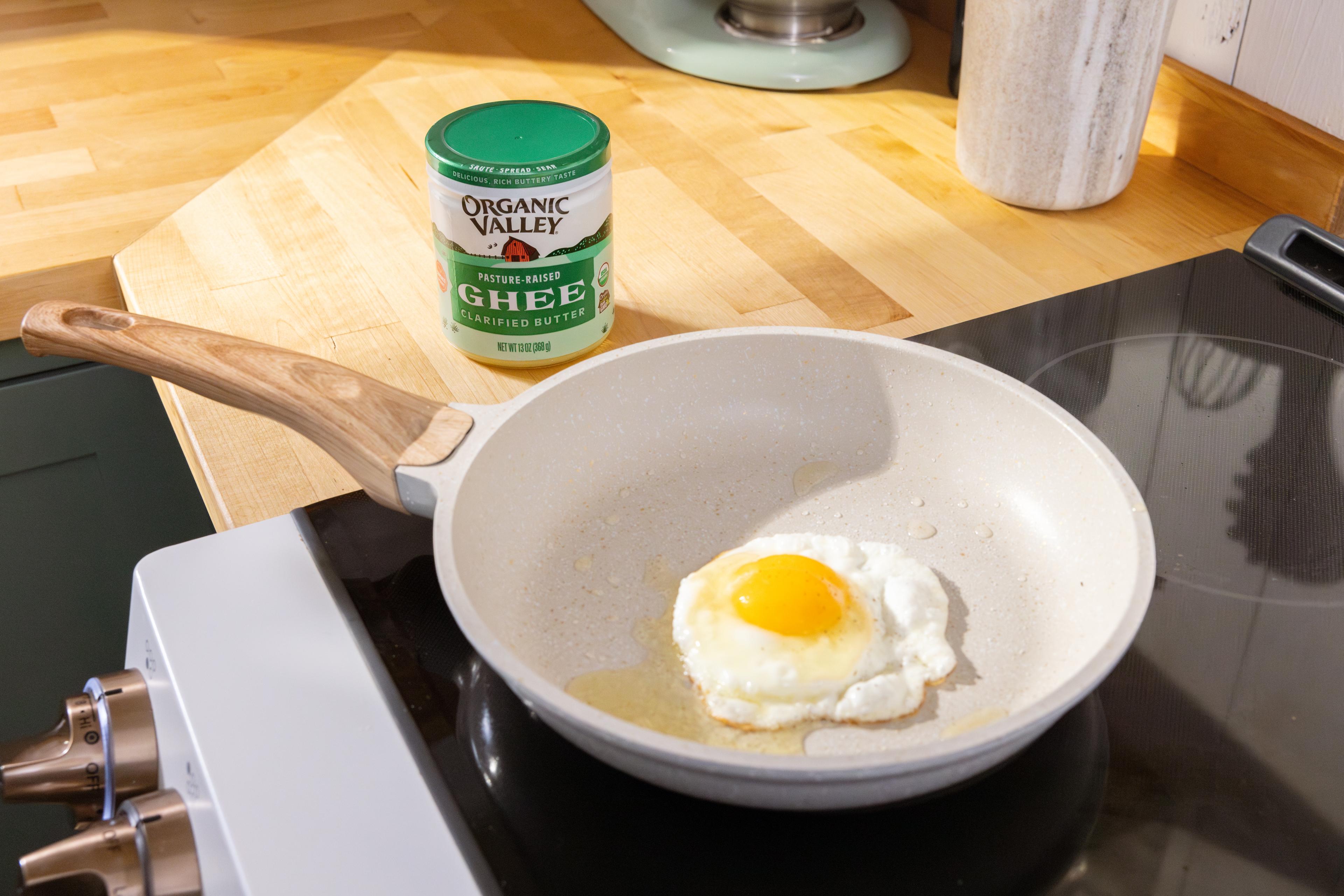 Eggs frying in a pan of ghee on the stovetop.