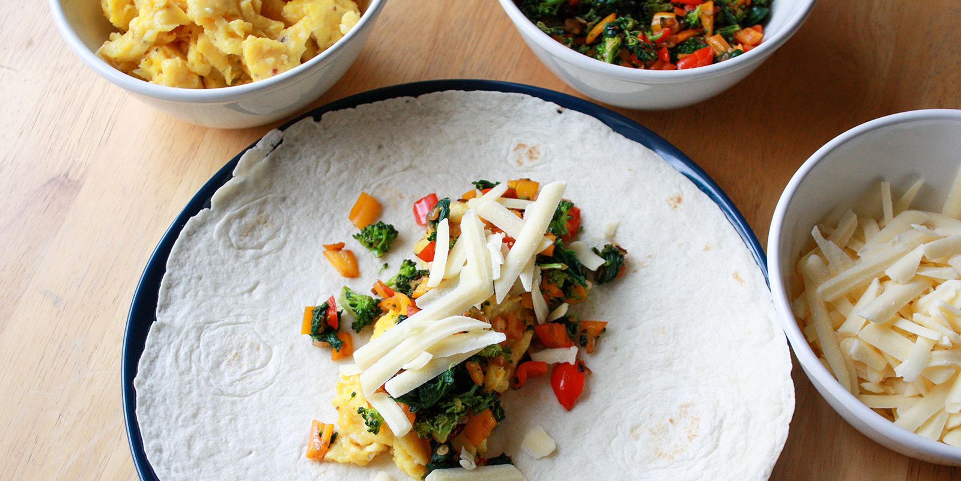 Breakfast egg burrito filling on top of a flour tortilla waiting to be wrapped. Photo by Annie Christianson.