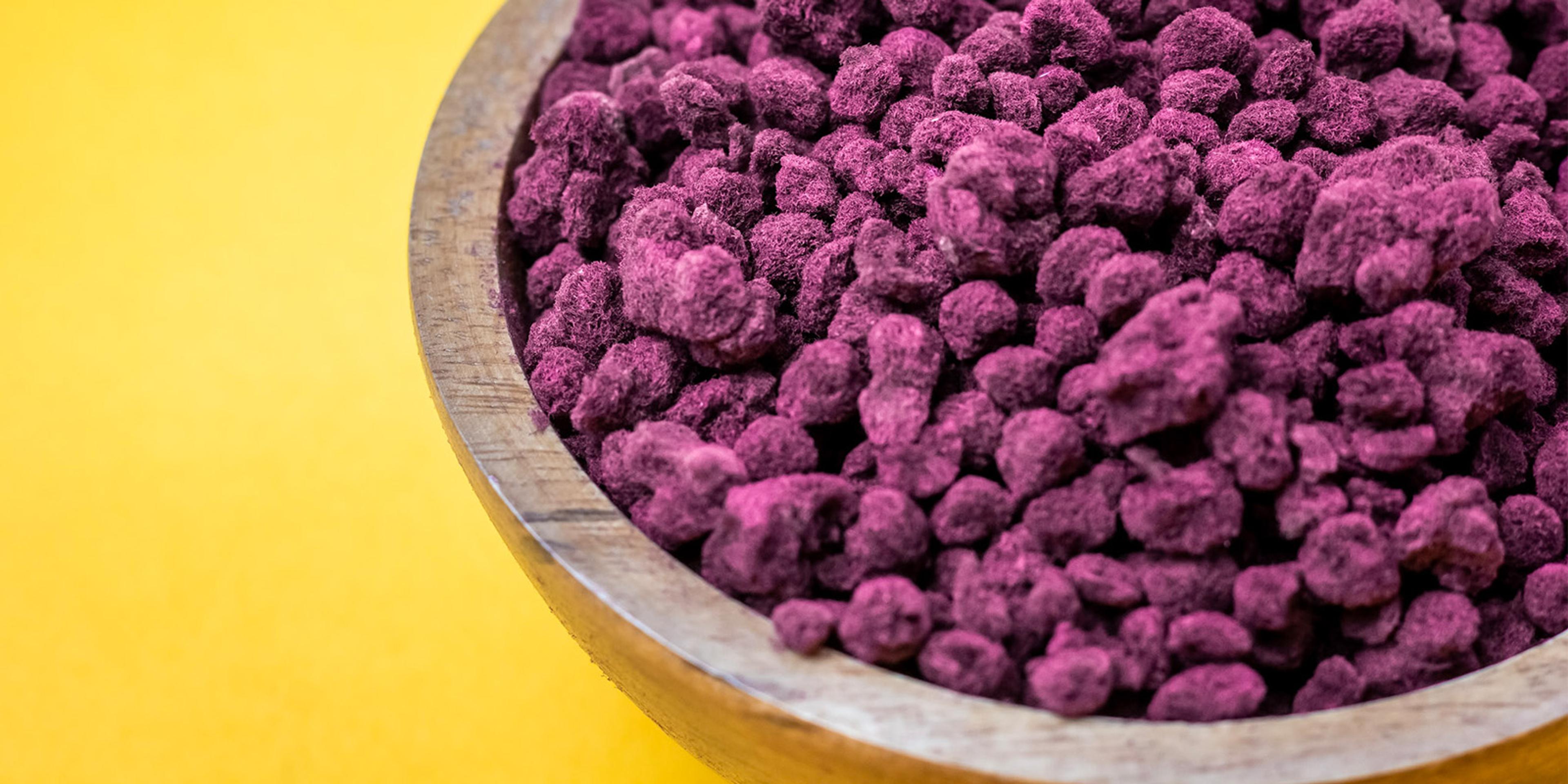A wooden bowl full of SeaGraze feed supplement.