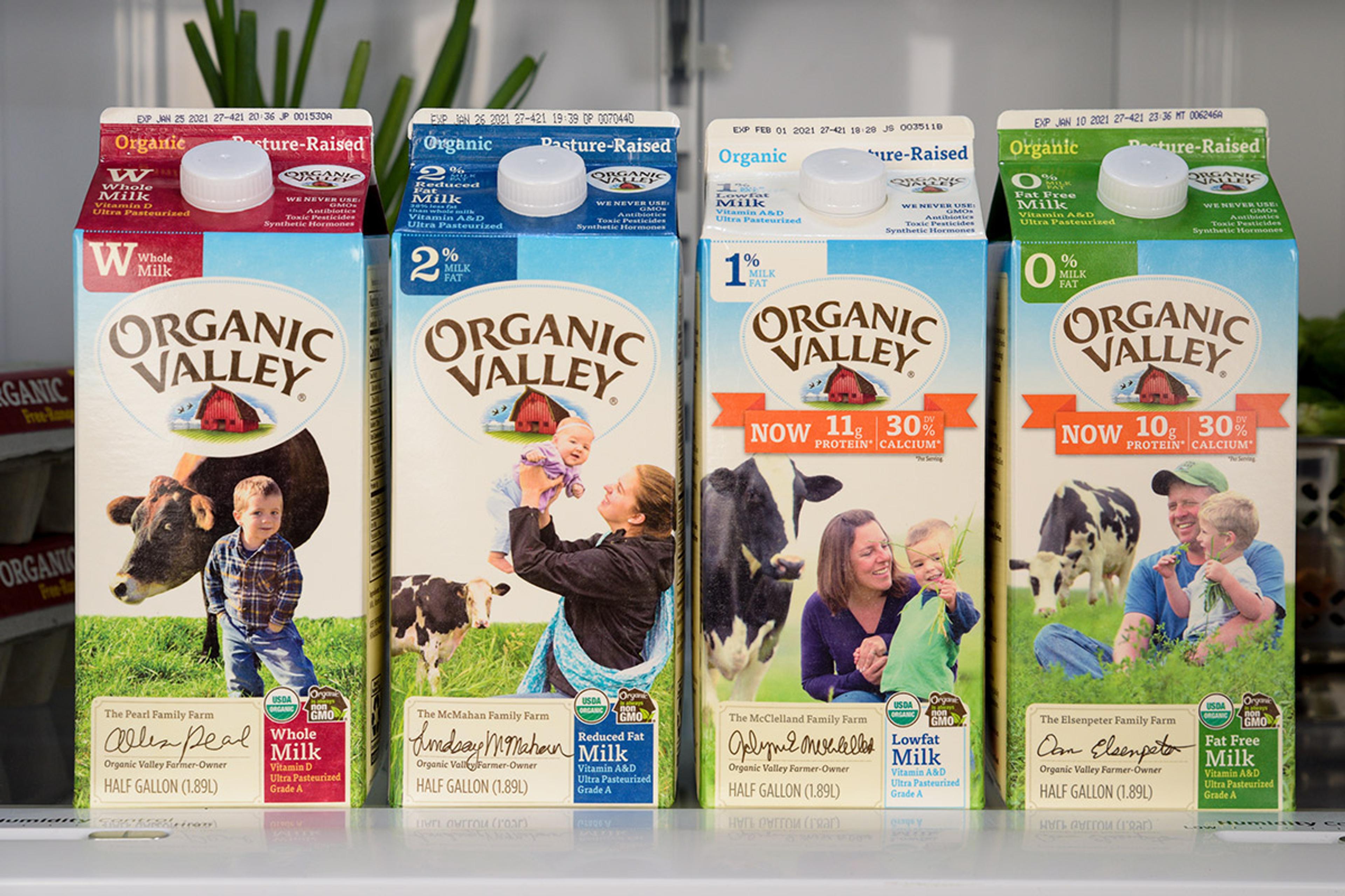 Organic Valley Milk products with open refrigerator in background.