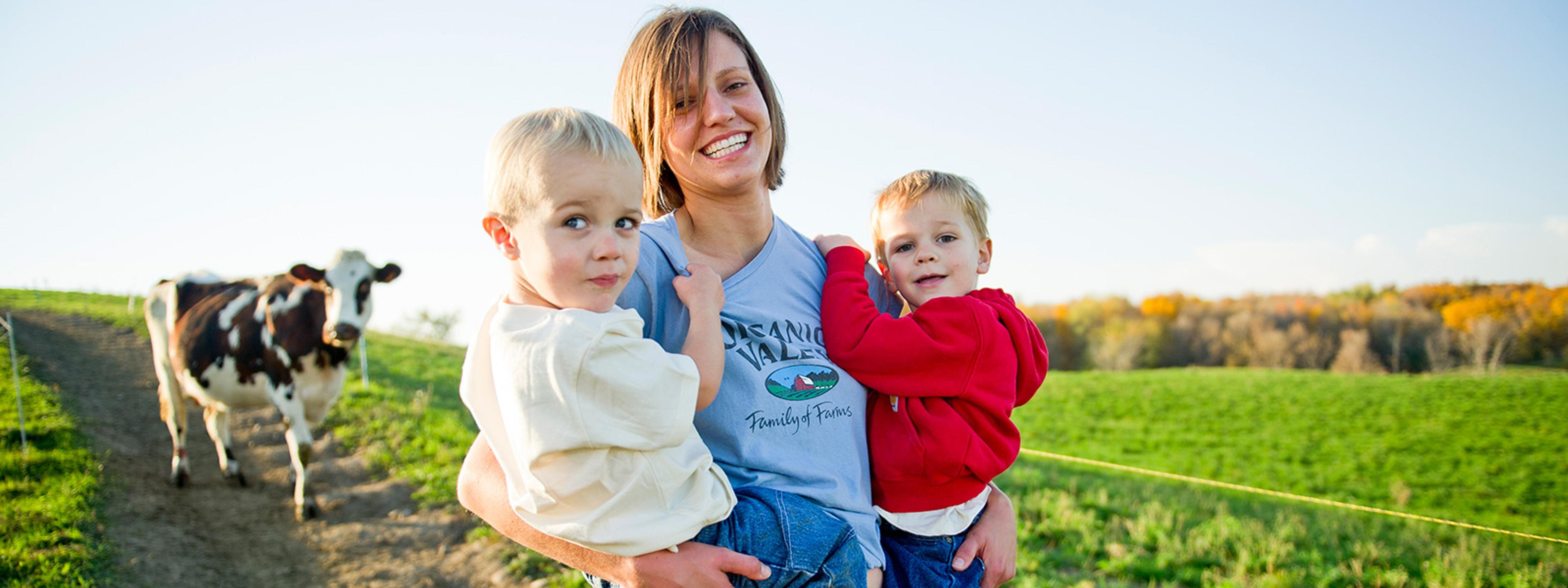 Emily Zweber holding her two young children.