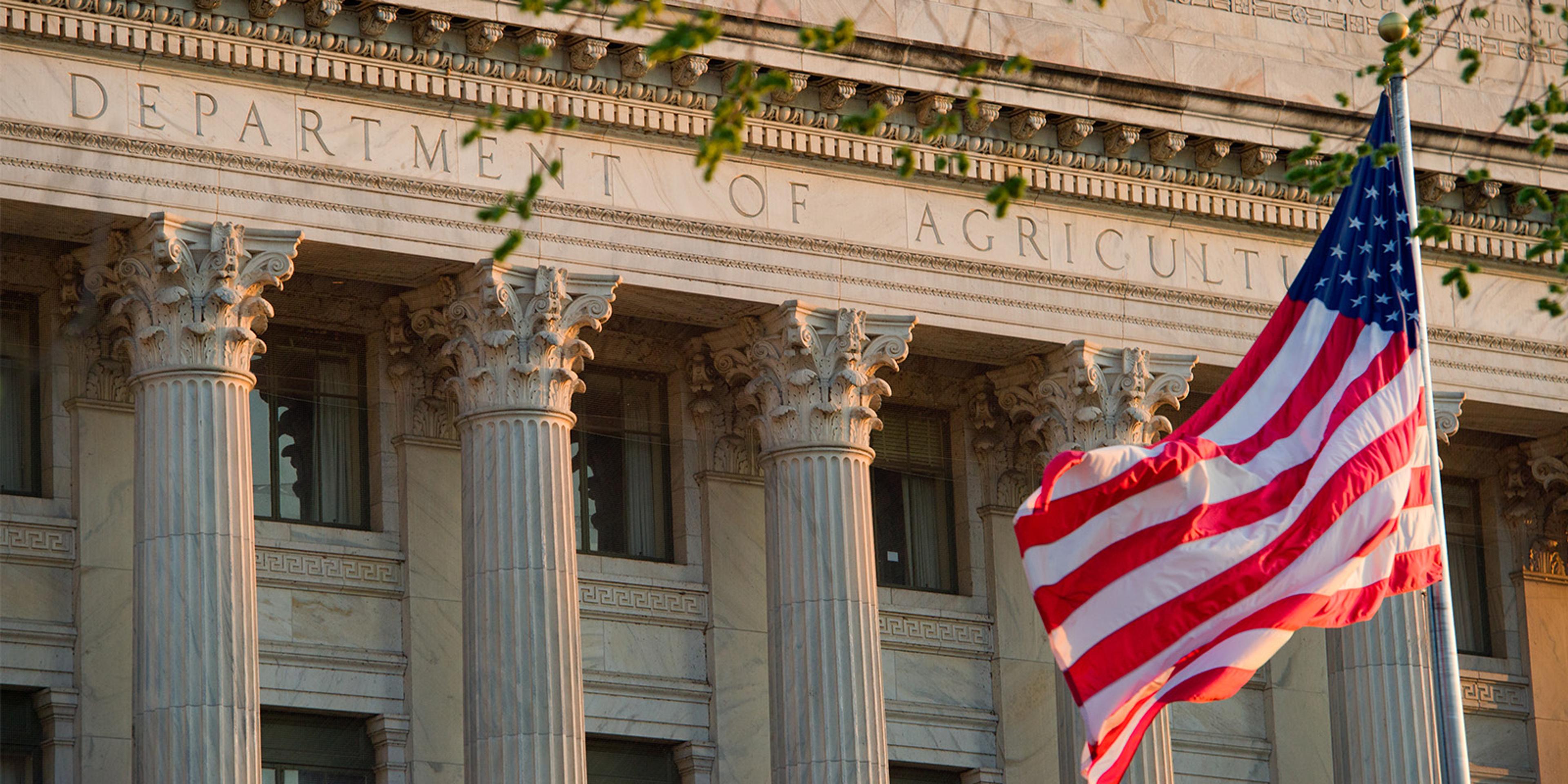 The U.S. Department of Agriculture building in Washington, D.C., with an American flag flying in front.