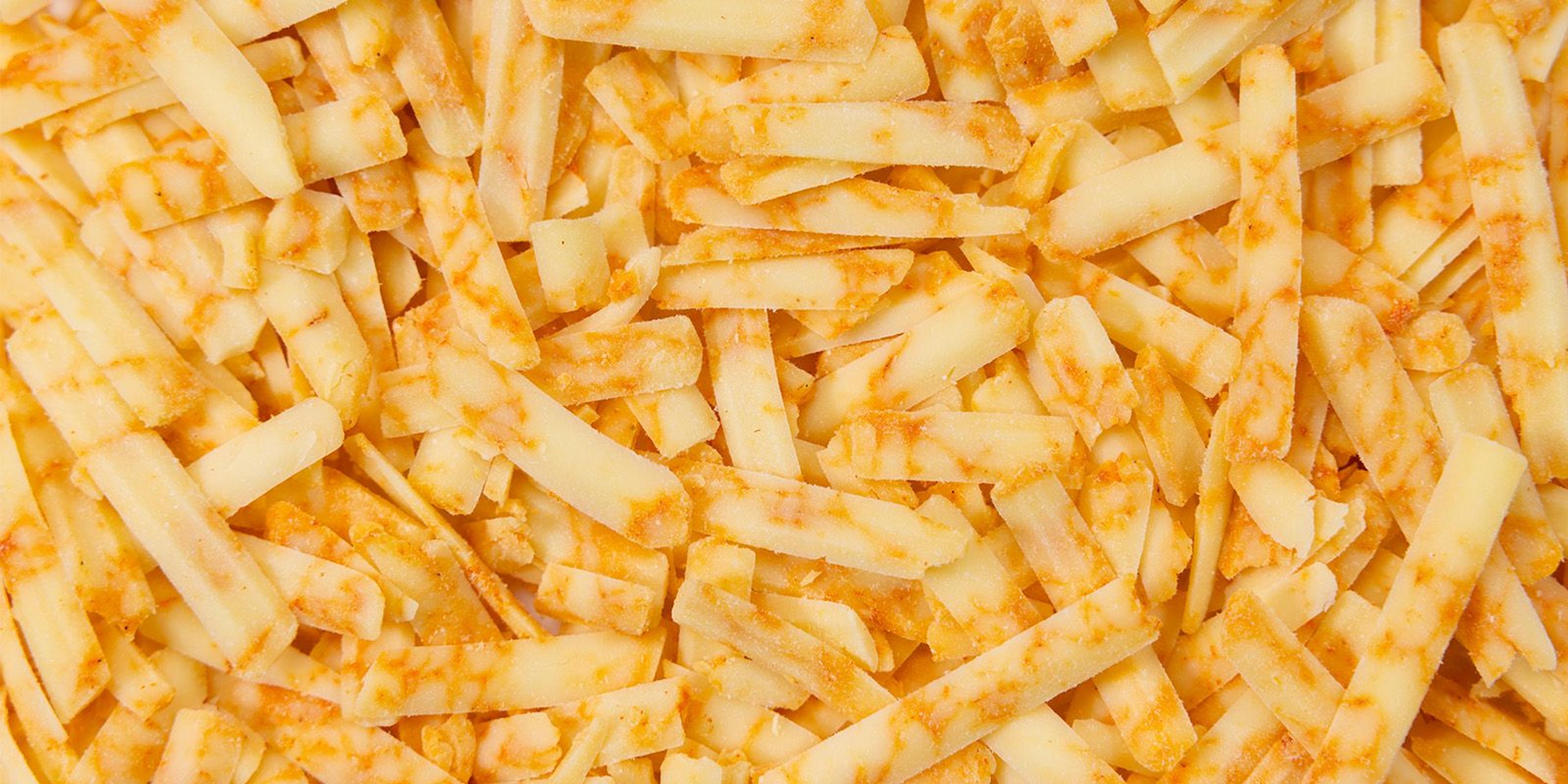 Thick cuts of shredded cheese that look like orange and white marbling.