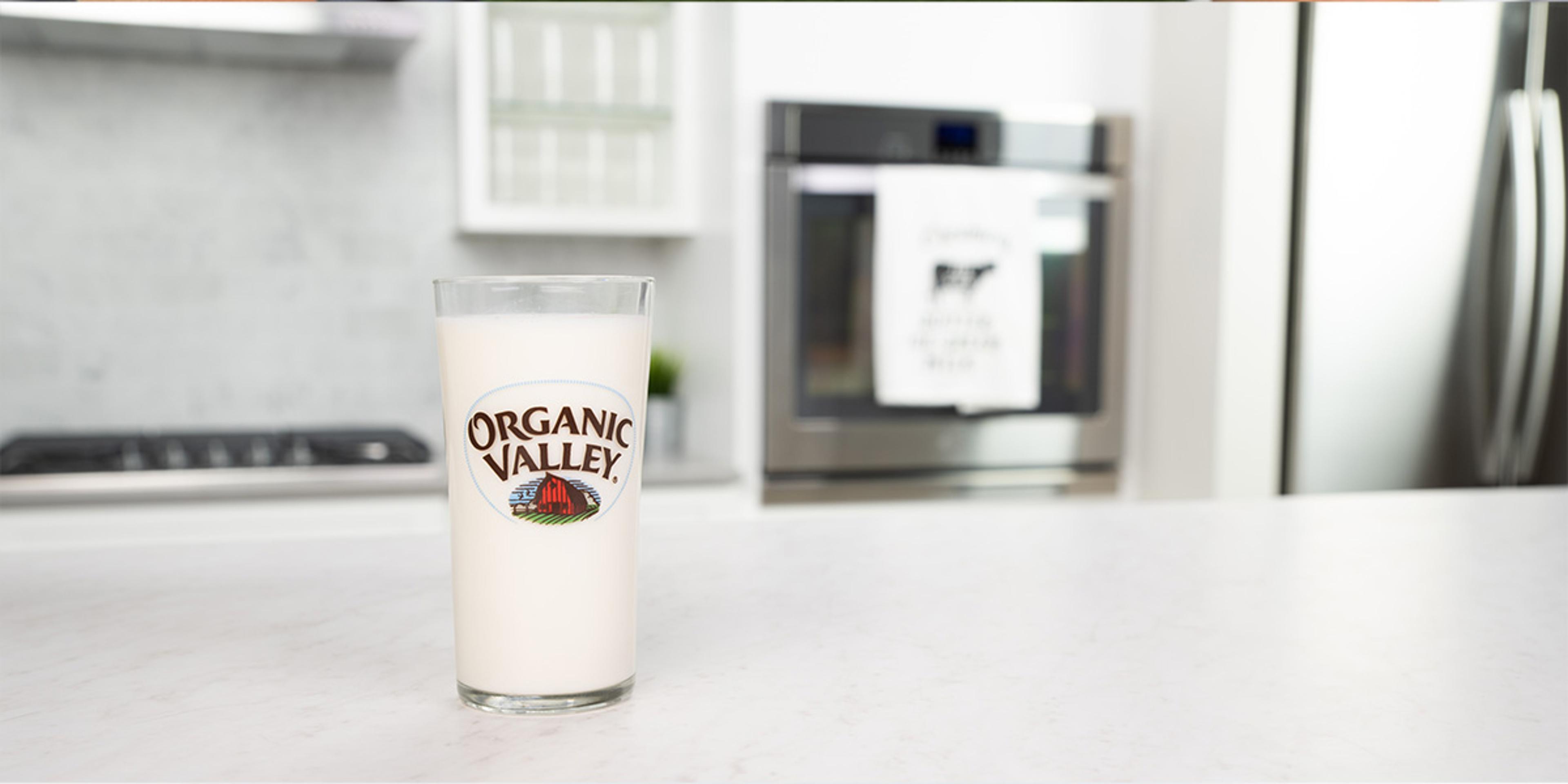 Milk in an Organic Valley glass sits on a counter.