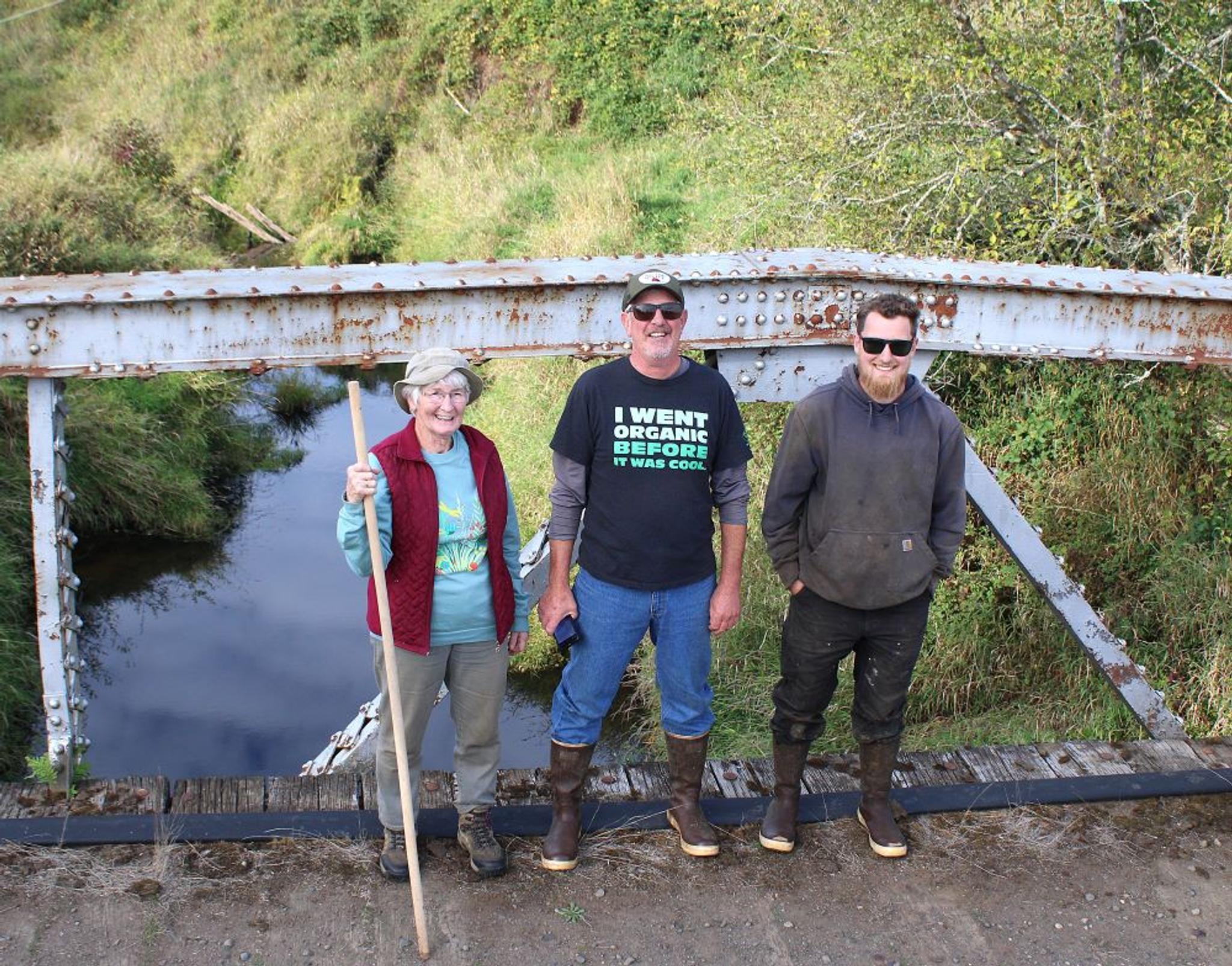 Family members stand on a bridge over Chehalis River. 