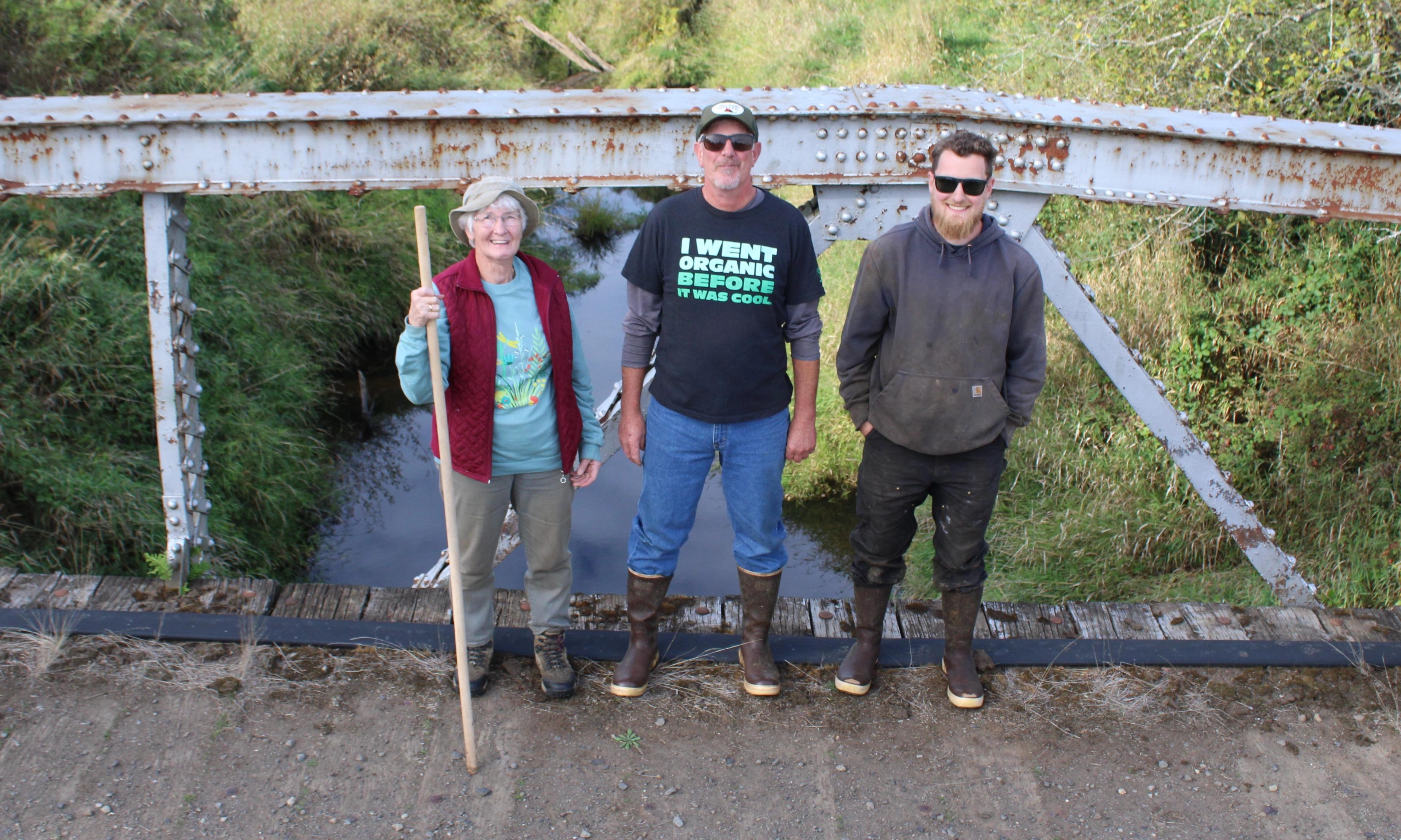 Three generations of the Mallonee family stand on a bridge.