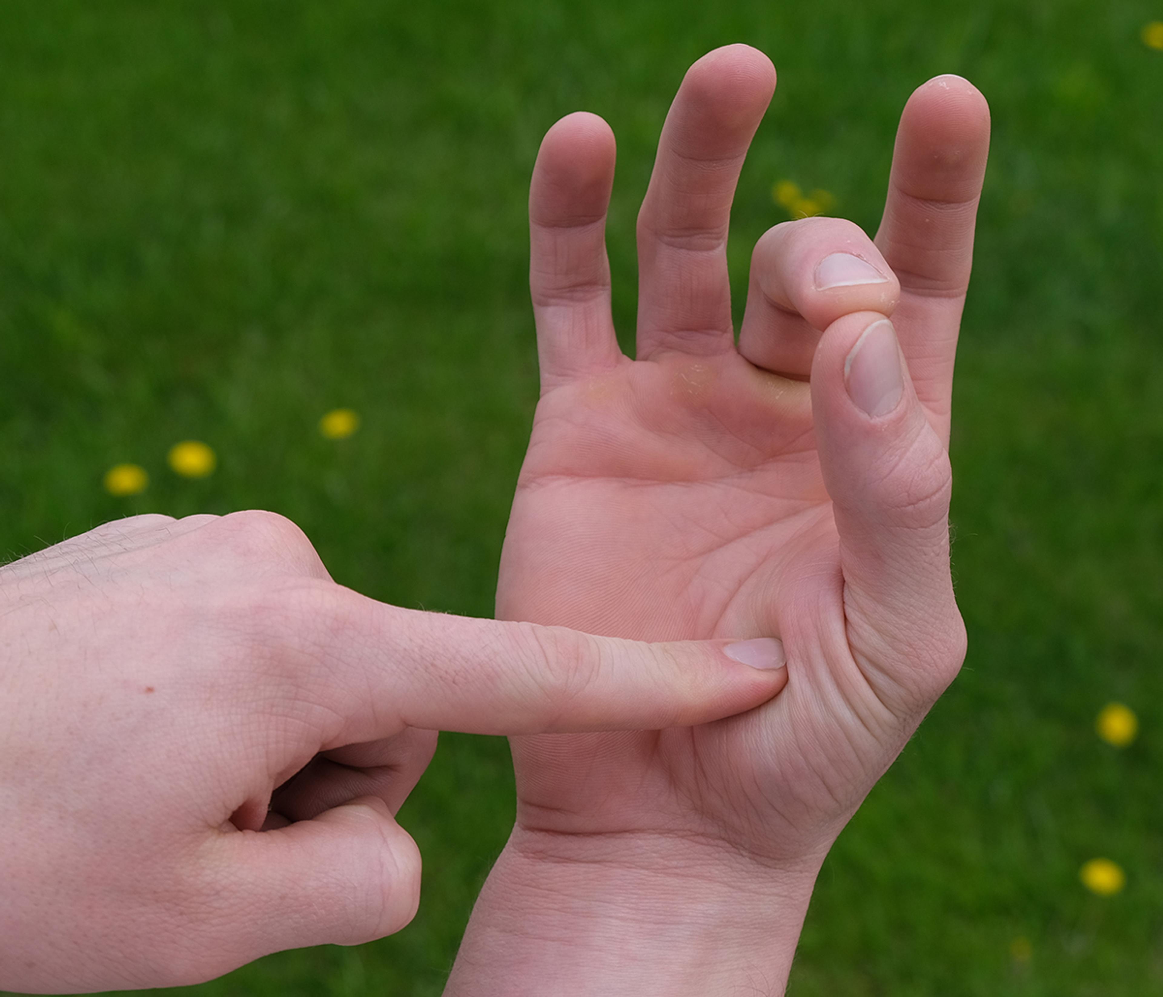 a man points to his hand.