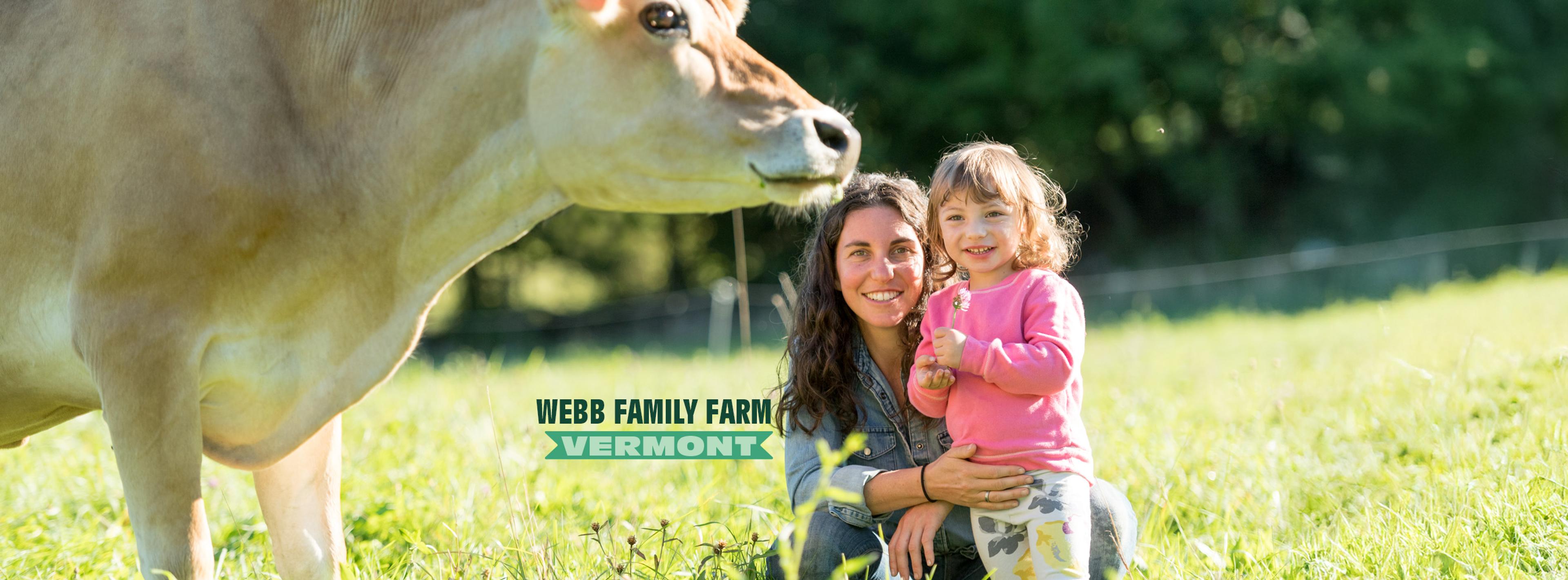 Cow in field with a woman and her child with a label that reads 'Webb Family Farm Vermont'.