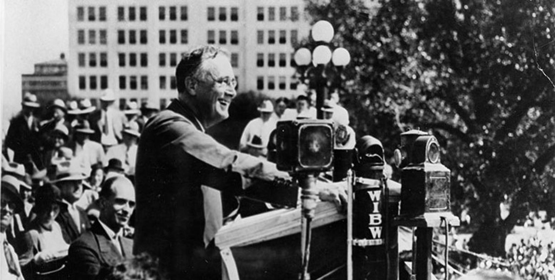 Franklin D. Roosevelt gives a campaign speech to farmers in Topeka, Kansas, on Sept. 14, 1932, promising them a “new deal.” To the left is James Roosevelt.