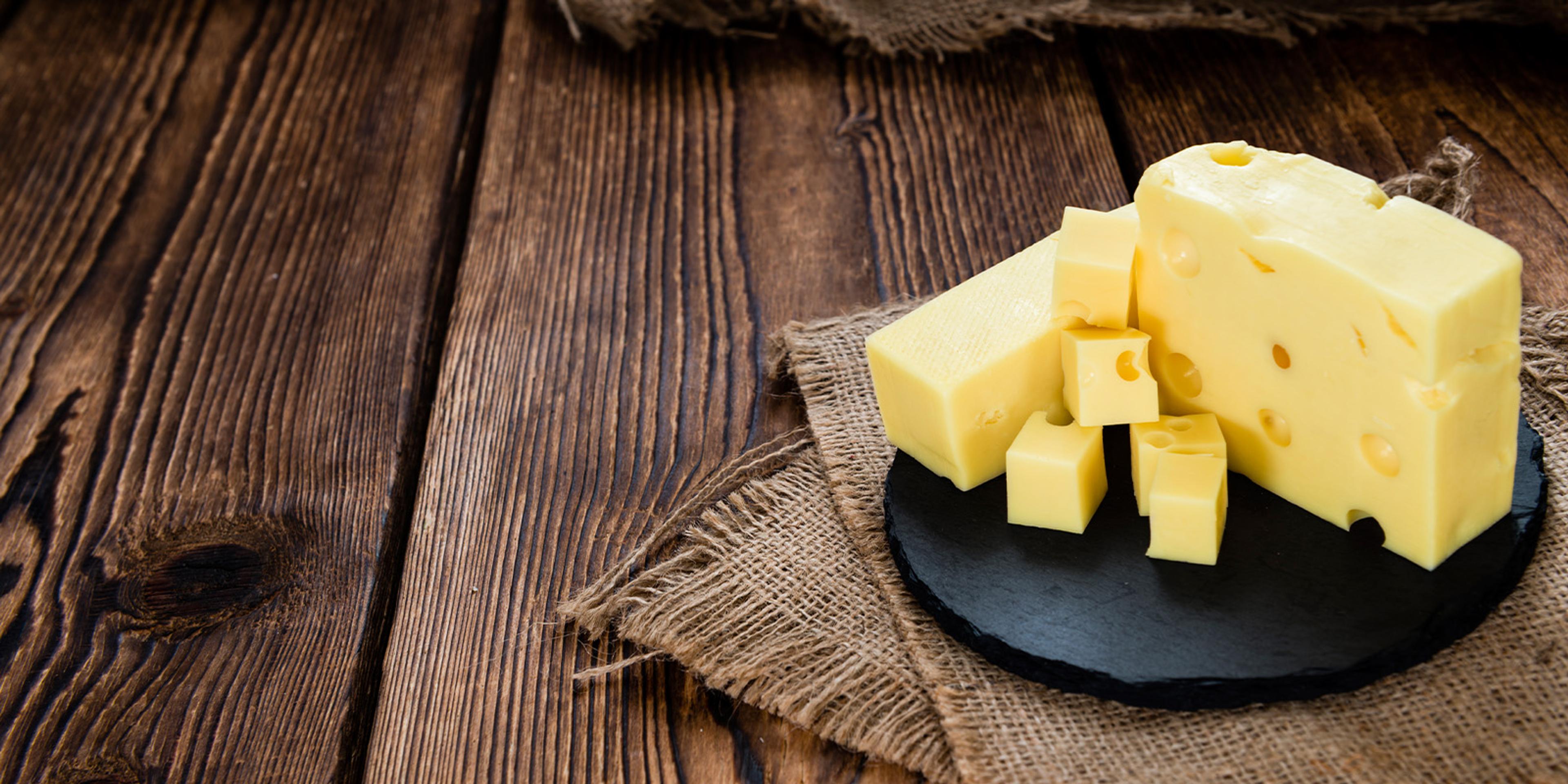 A plate of Organic Valley Baby Swiss Cheese cut into cubes and blocks.