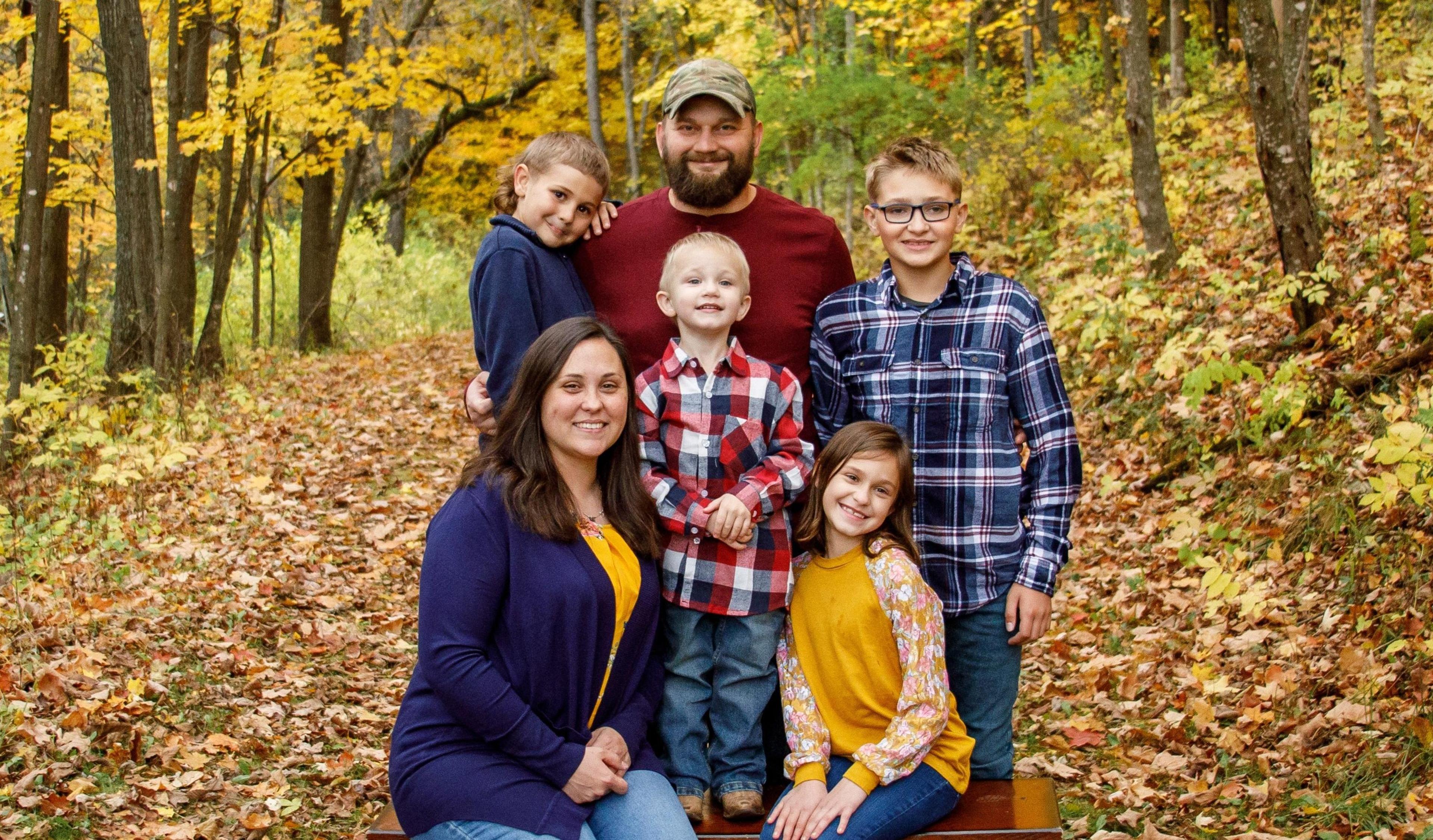 The Palmer family poses for a photo in fall in Wisconsin.