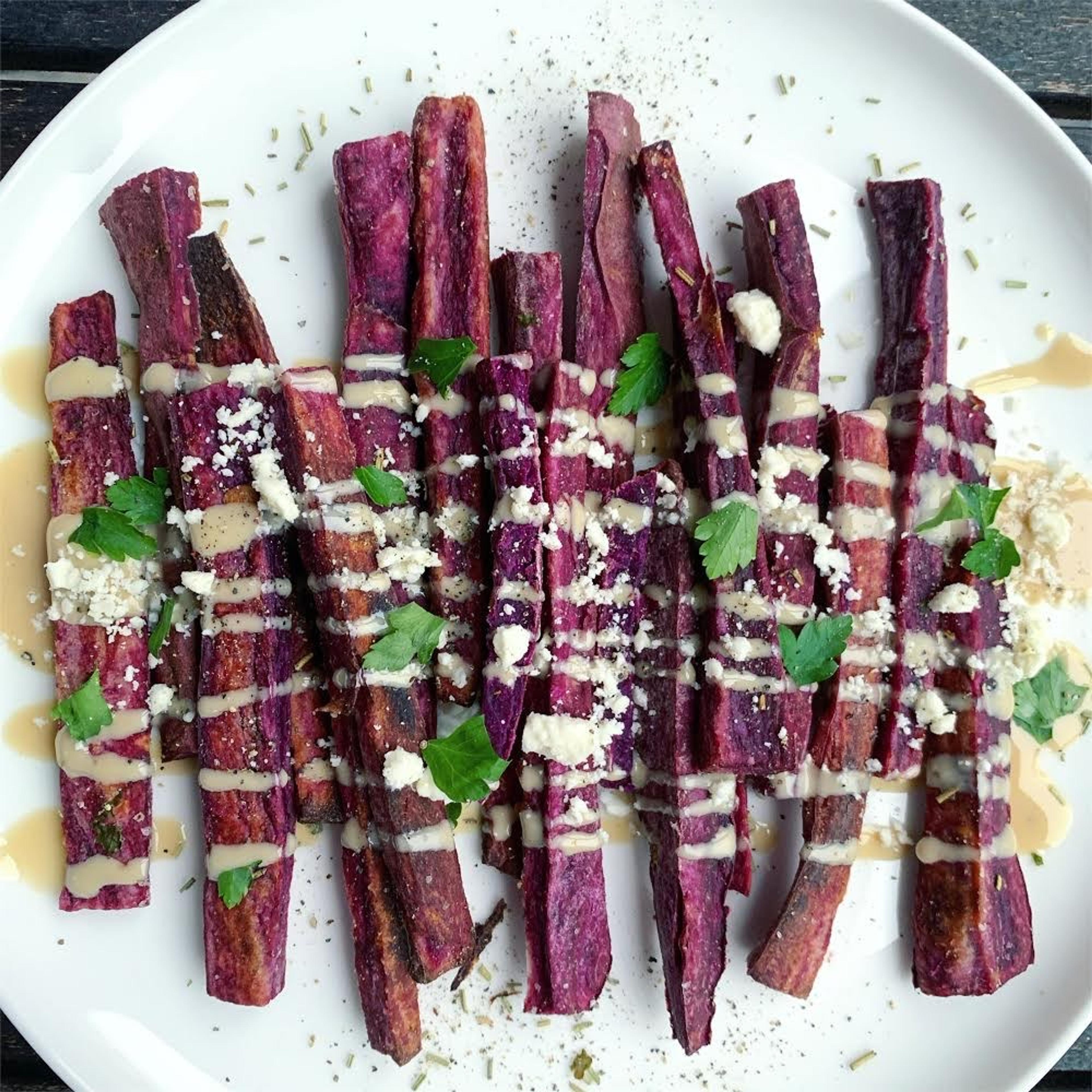 Purple sweet potato slices drizzled with tahini sauce. Photo contributed by Jennifer Combs.