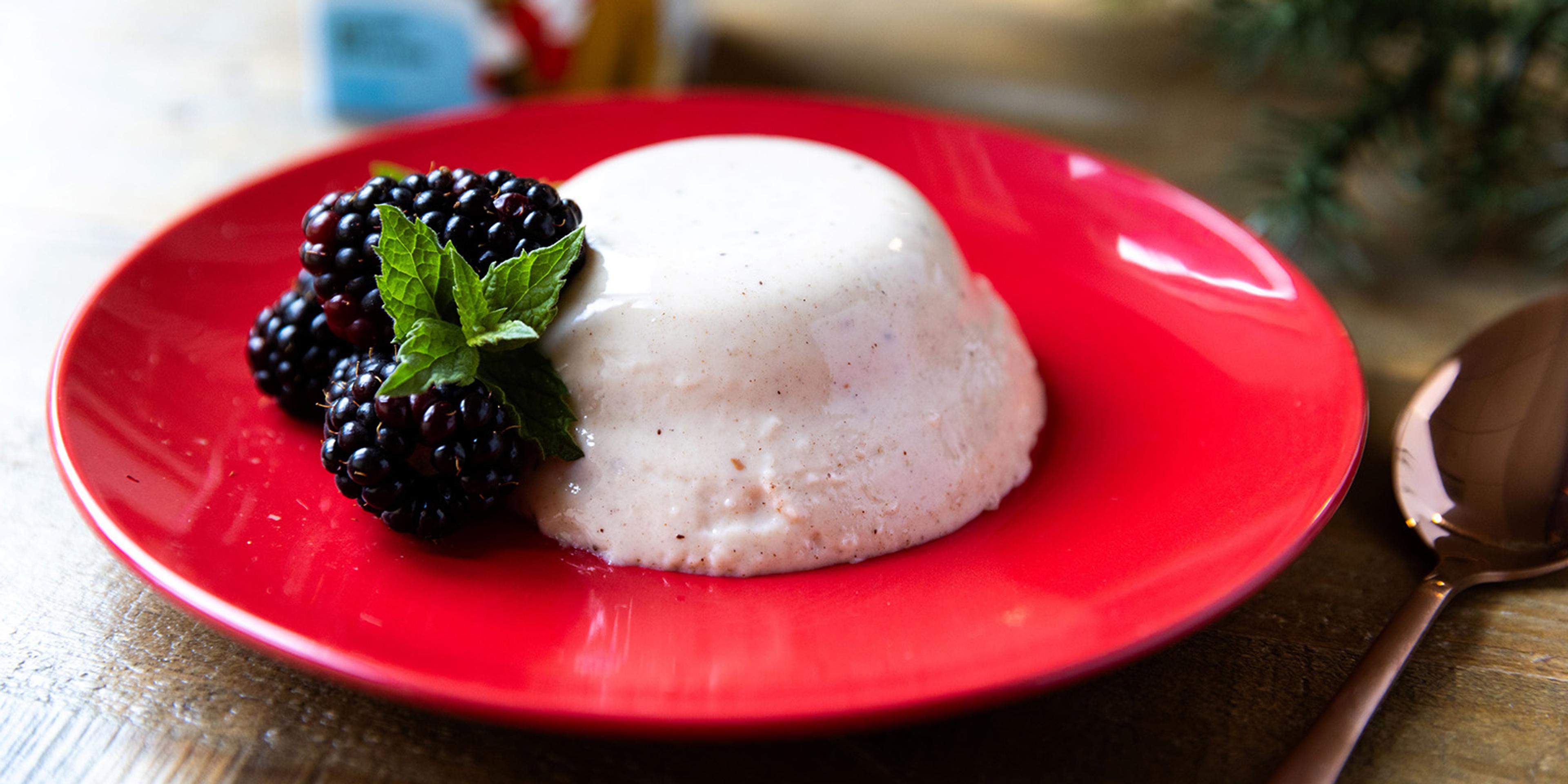 Panna Cotta made with Organic Valley Eggnog on a plate garnished with berries.