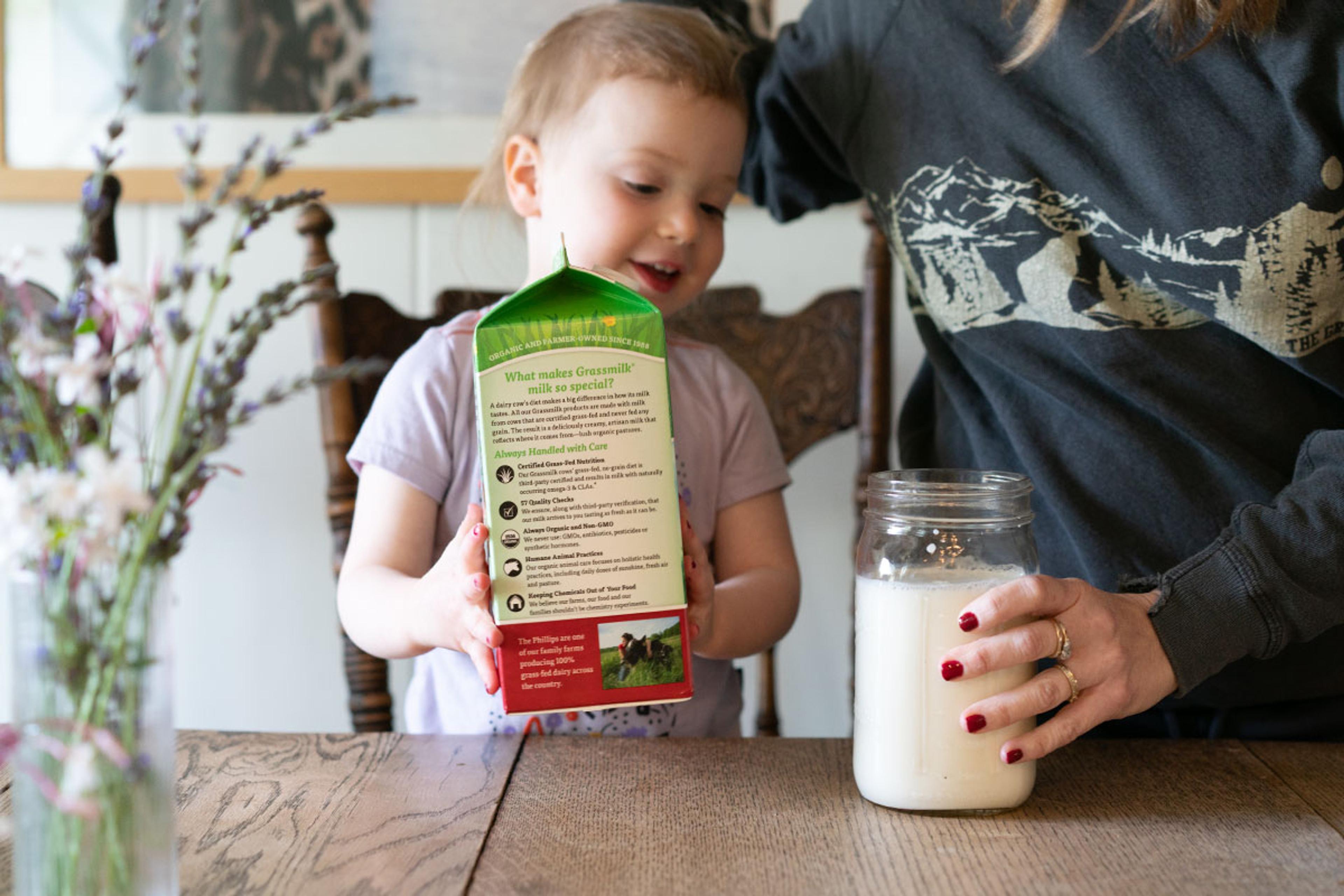 Pouring organic, grass-fed milk into a mason jar.