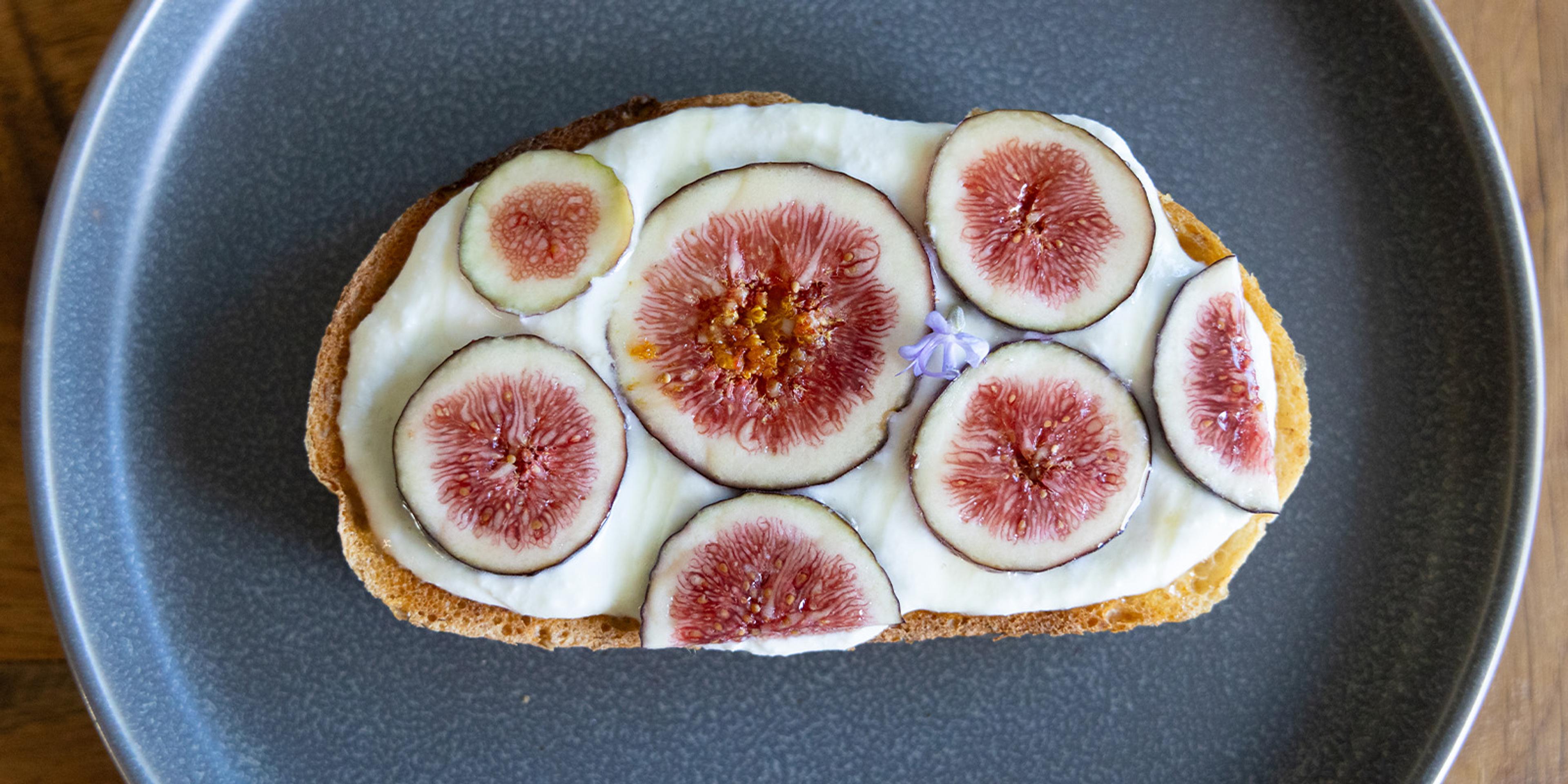 Whipped Organic Valley® Ricotta Cheese on sourdough toast with fig and honey.