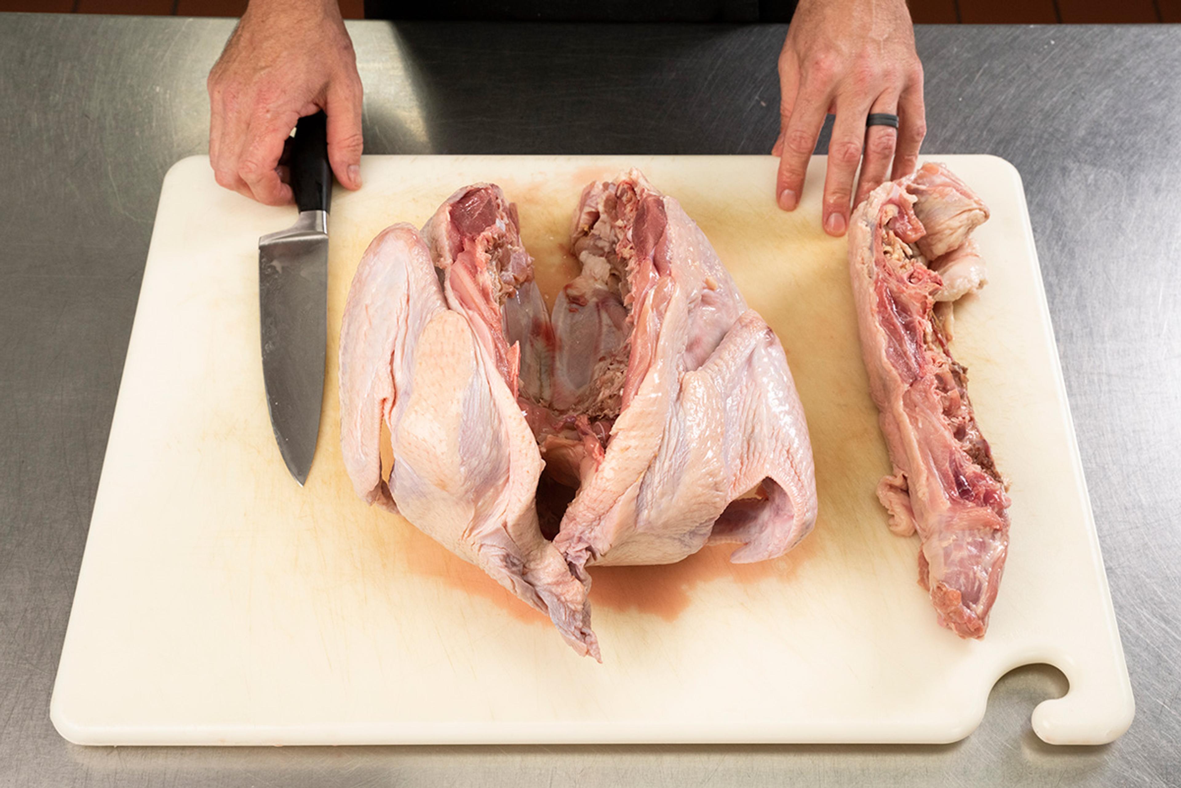 Once you cut down the sides of the backbone you can remove it.