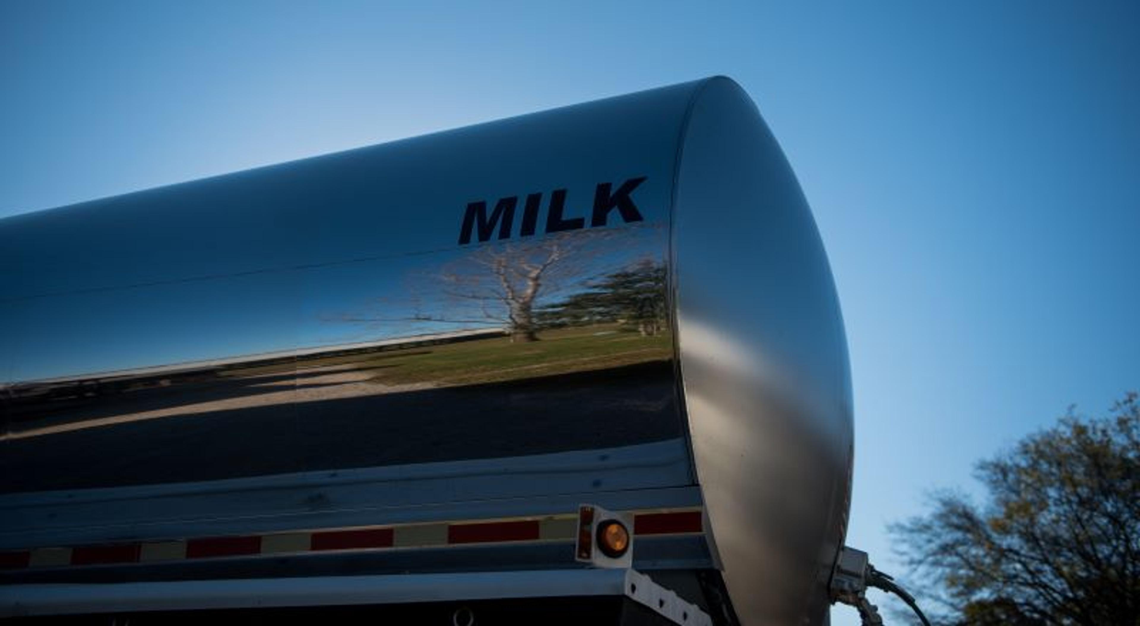 A milk tanker with the word "milk" on the side.