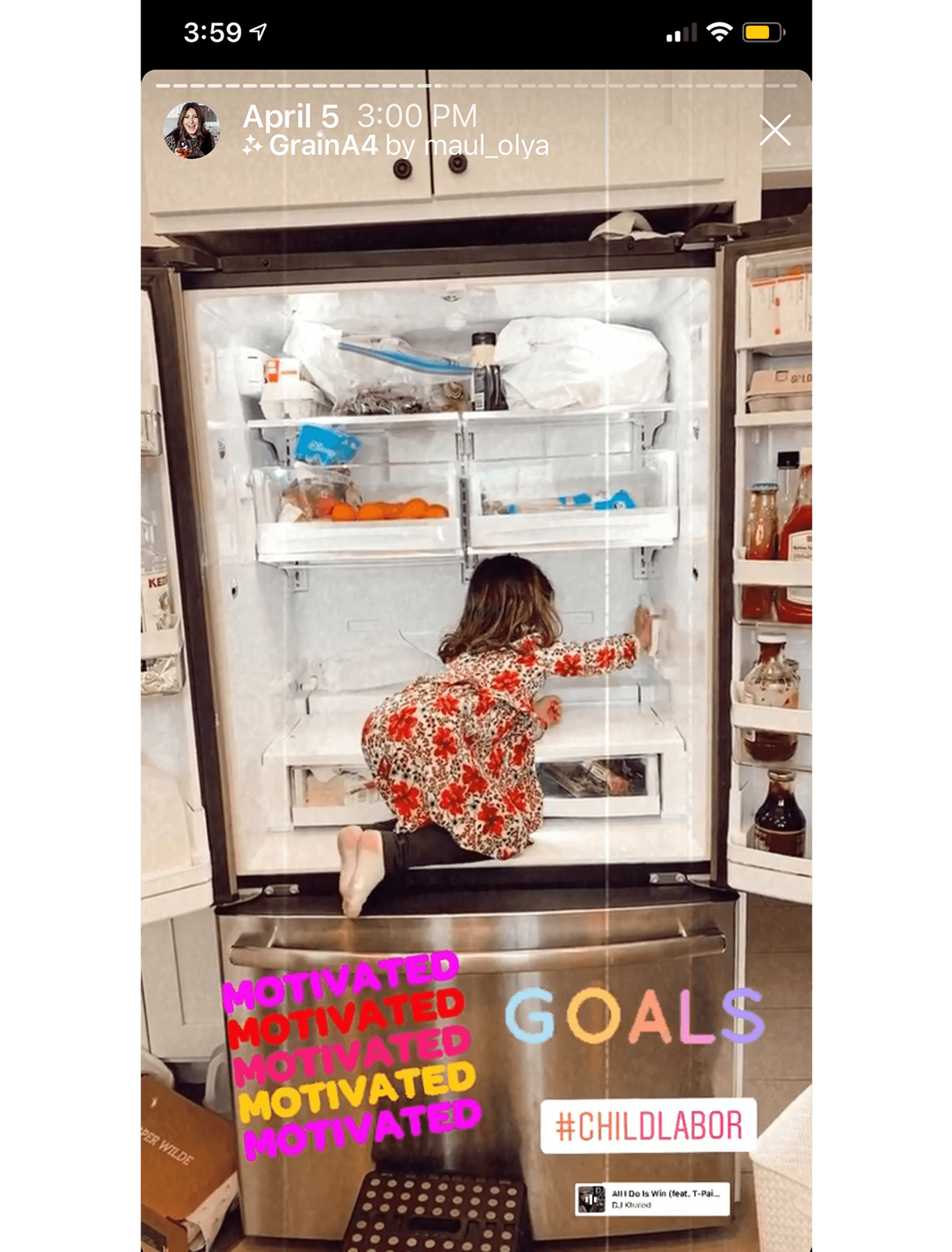 A little girl is kneeling inside the fridge while cleaning the shelves.
