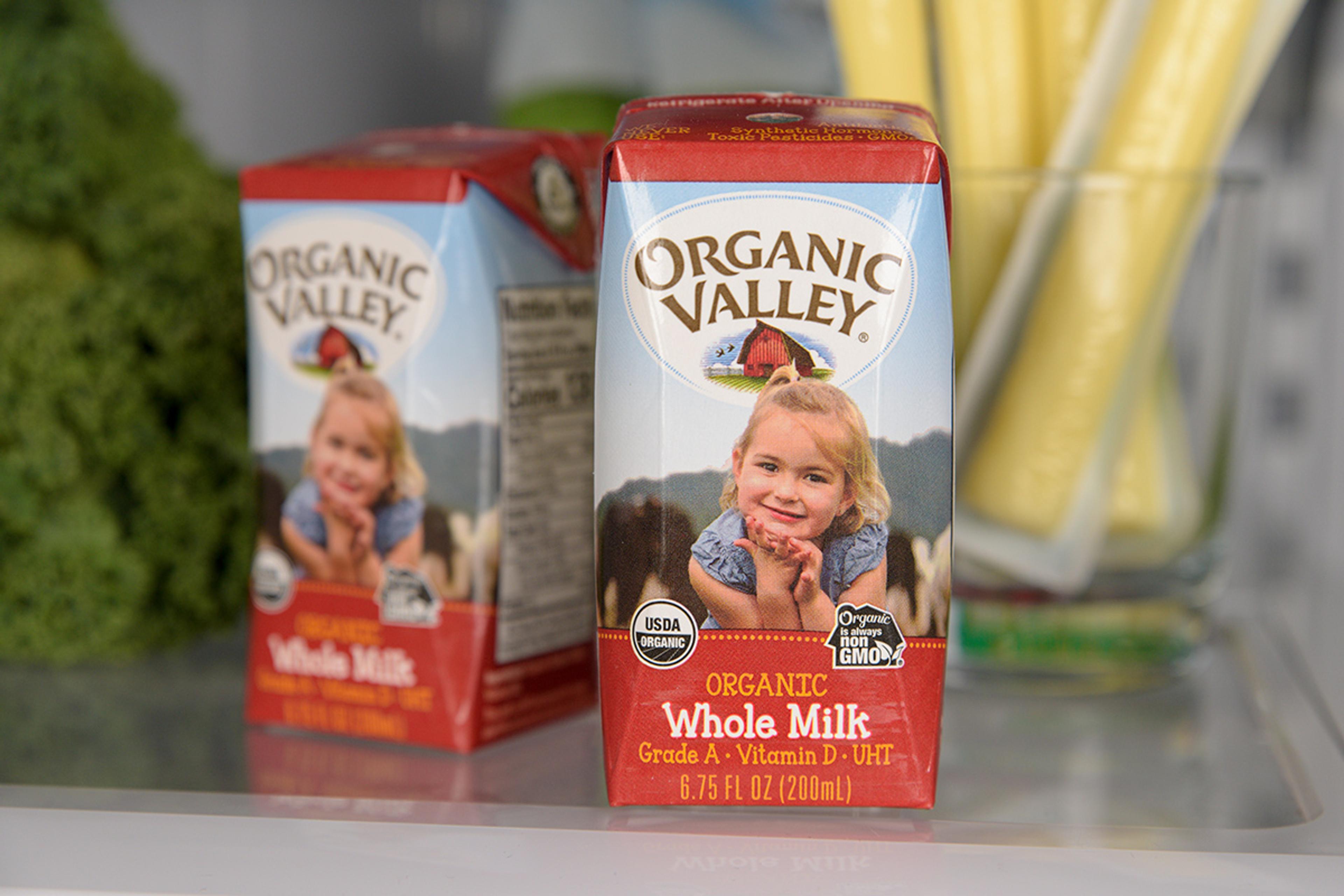 Organic Valley shelf stable milk displayed on a fridge shelf.