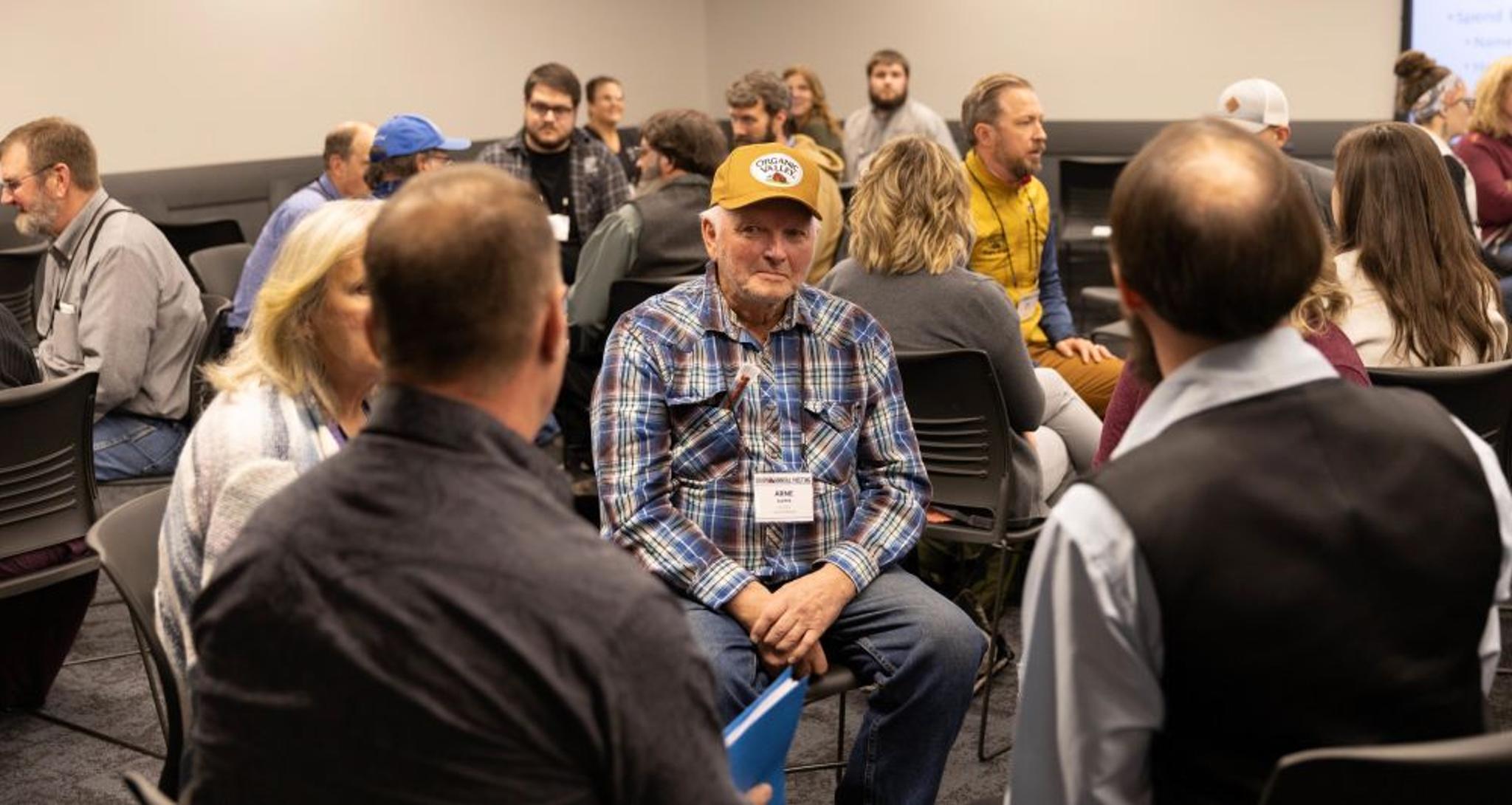 Co-op farmers and employees talk.