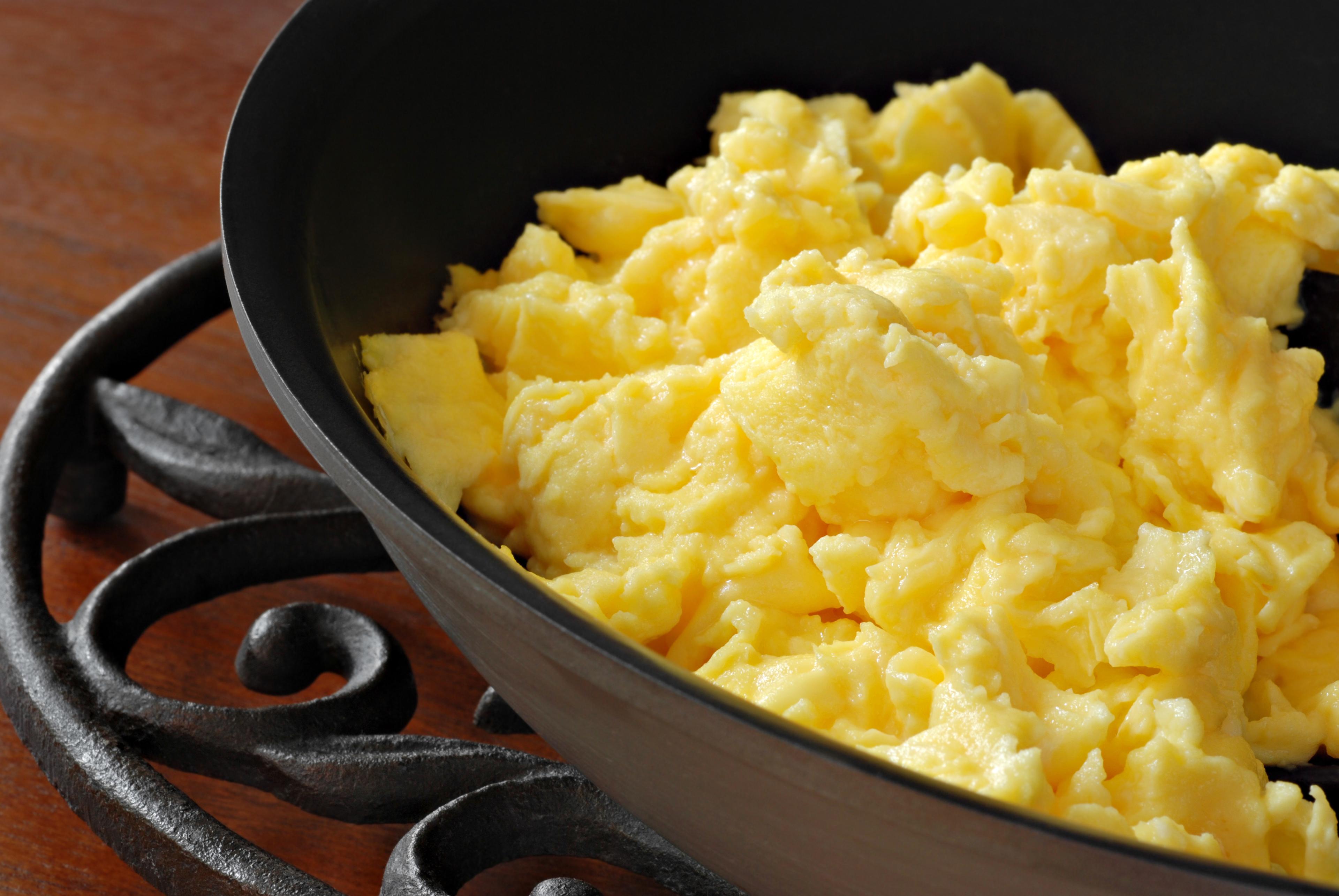 A wooden basket of organic eggs set on green grass at the Goede family farm in Wisconsin.