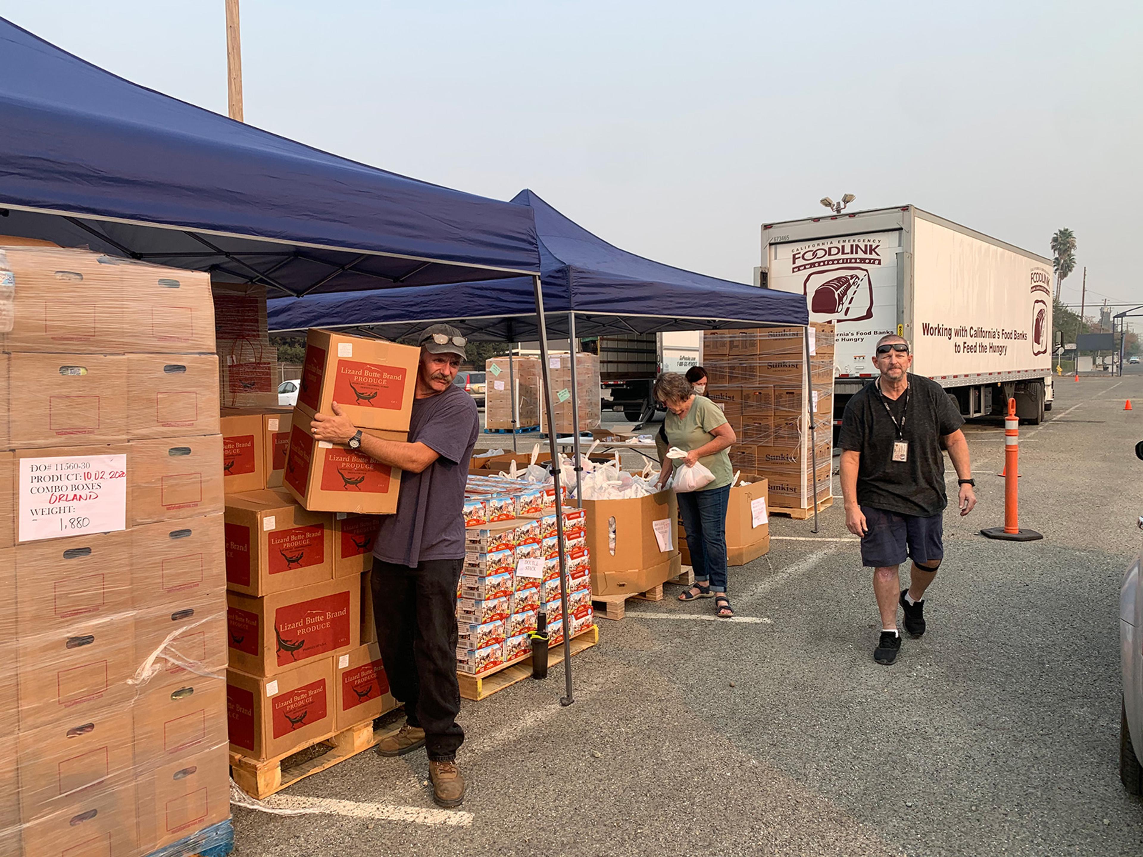 Volunteers share goods and food with community members affecting by the wildfires.