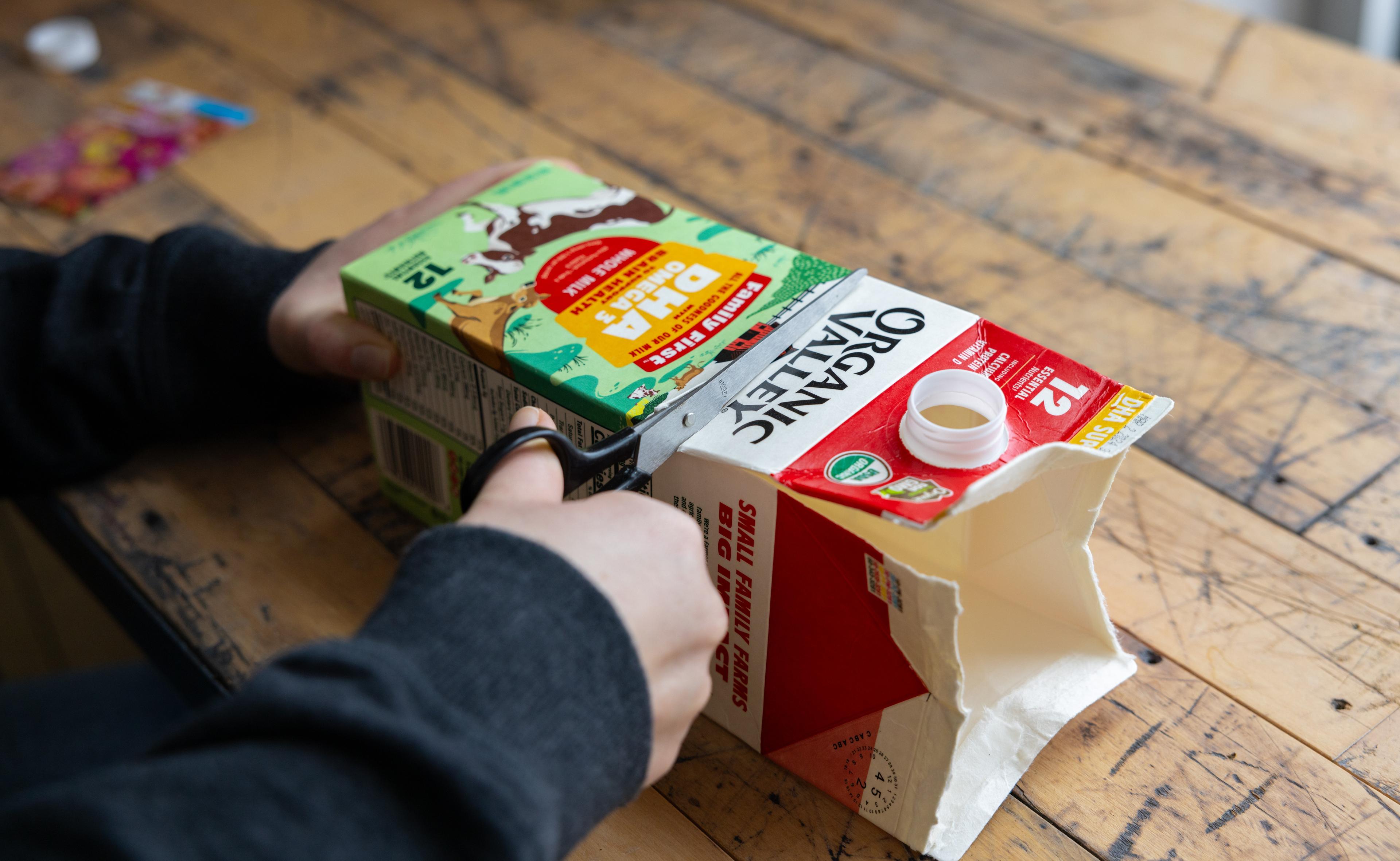 Cutting the Organic Valley Grassmilk carton to hold dirt and seeds.