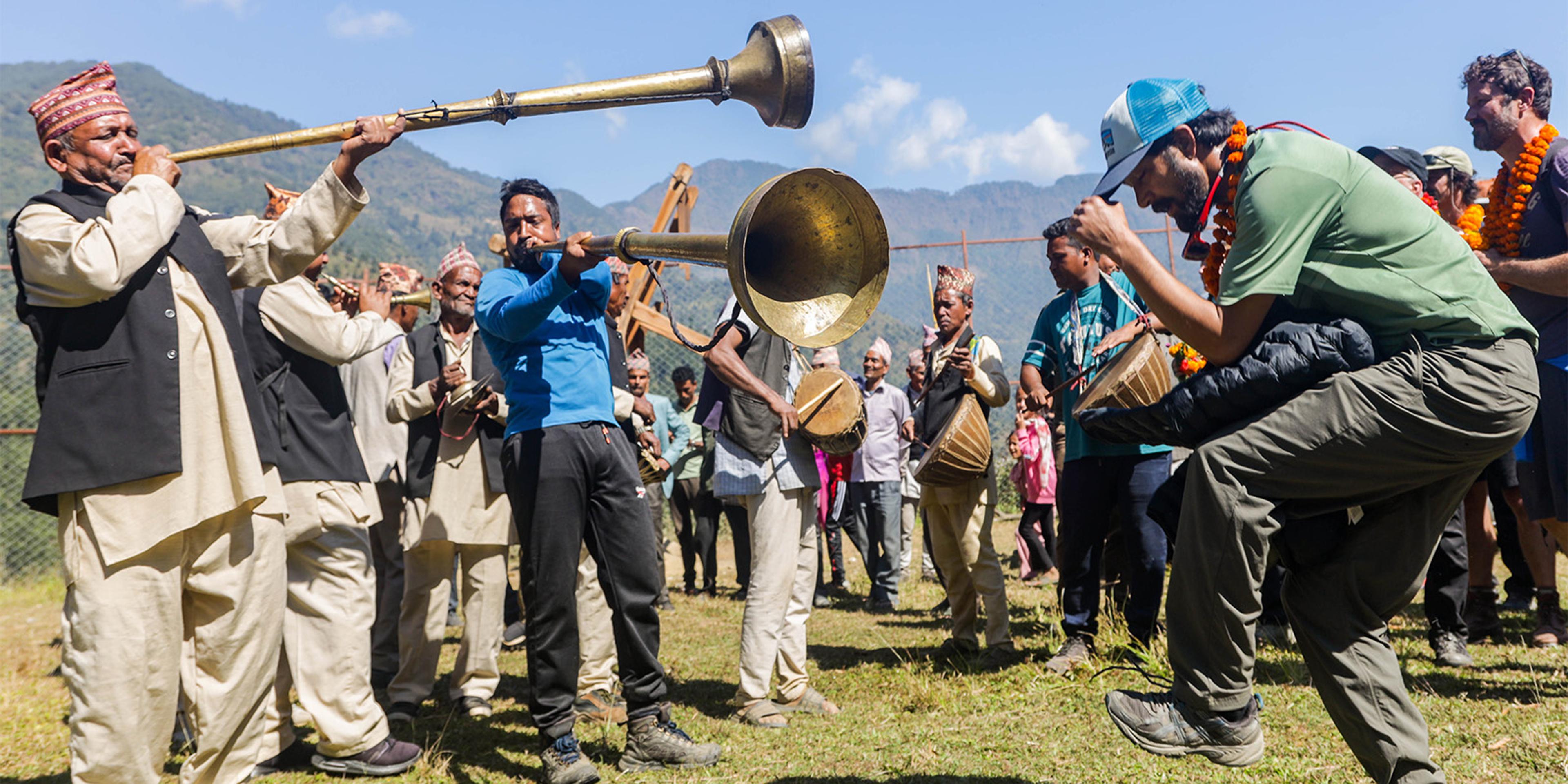 A band welcomes volunteers to Binjel, Nepal