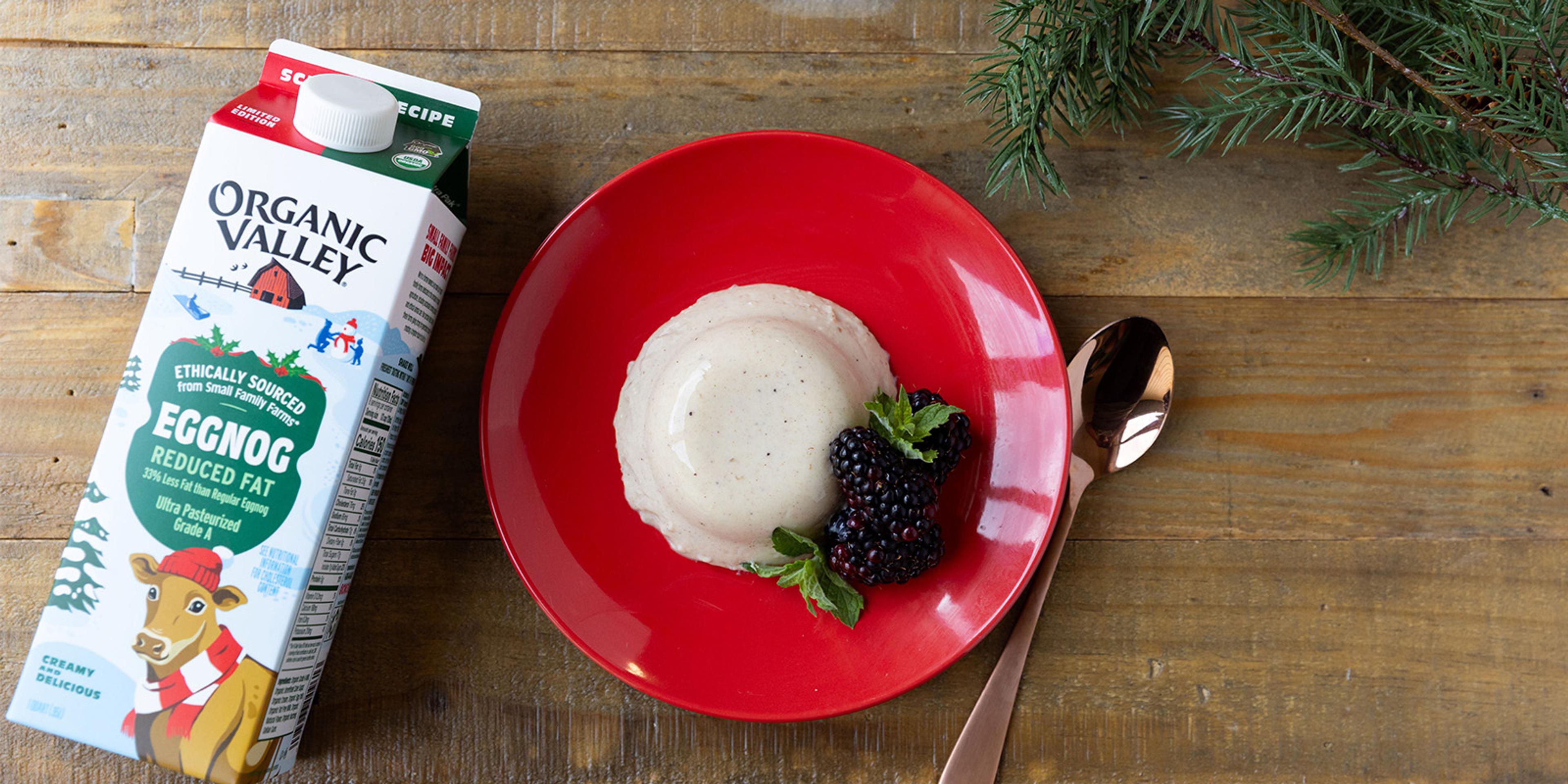 Panna Cotta made with Organic Valley Reduced Fat Eggnog on a plate with berries.