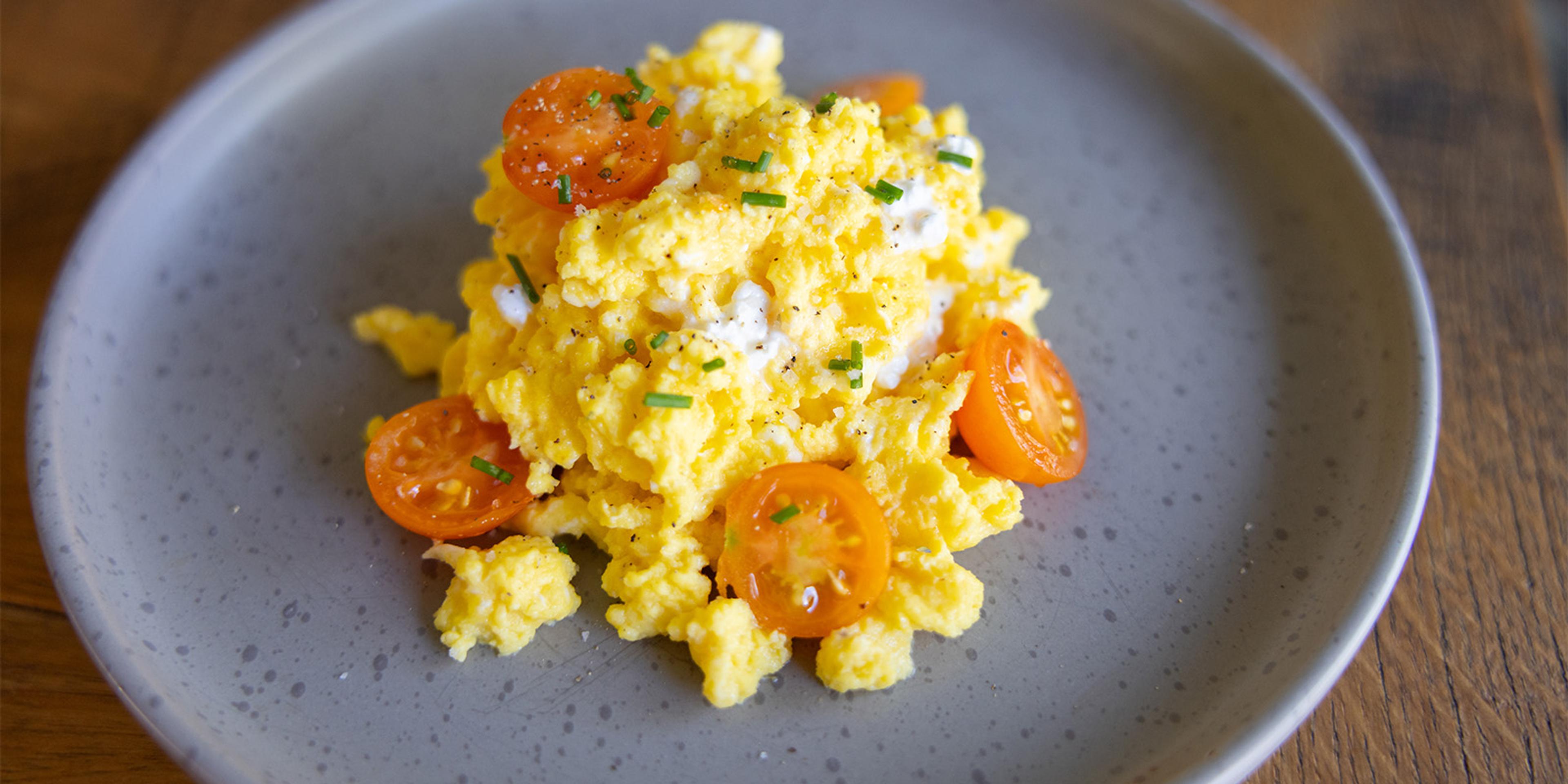 Scrambled eggs made with cottage cheese with tomatoes and chives.