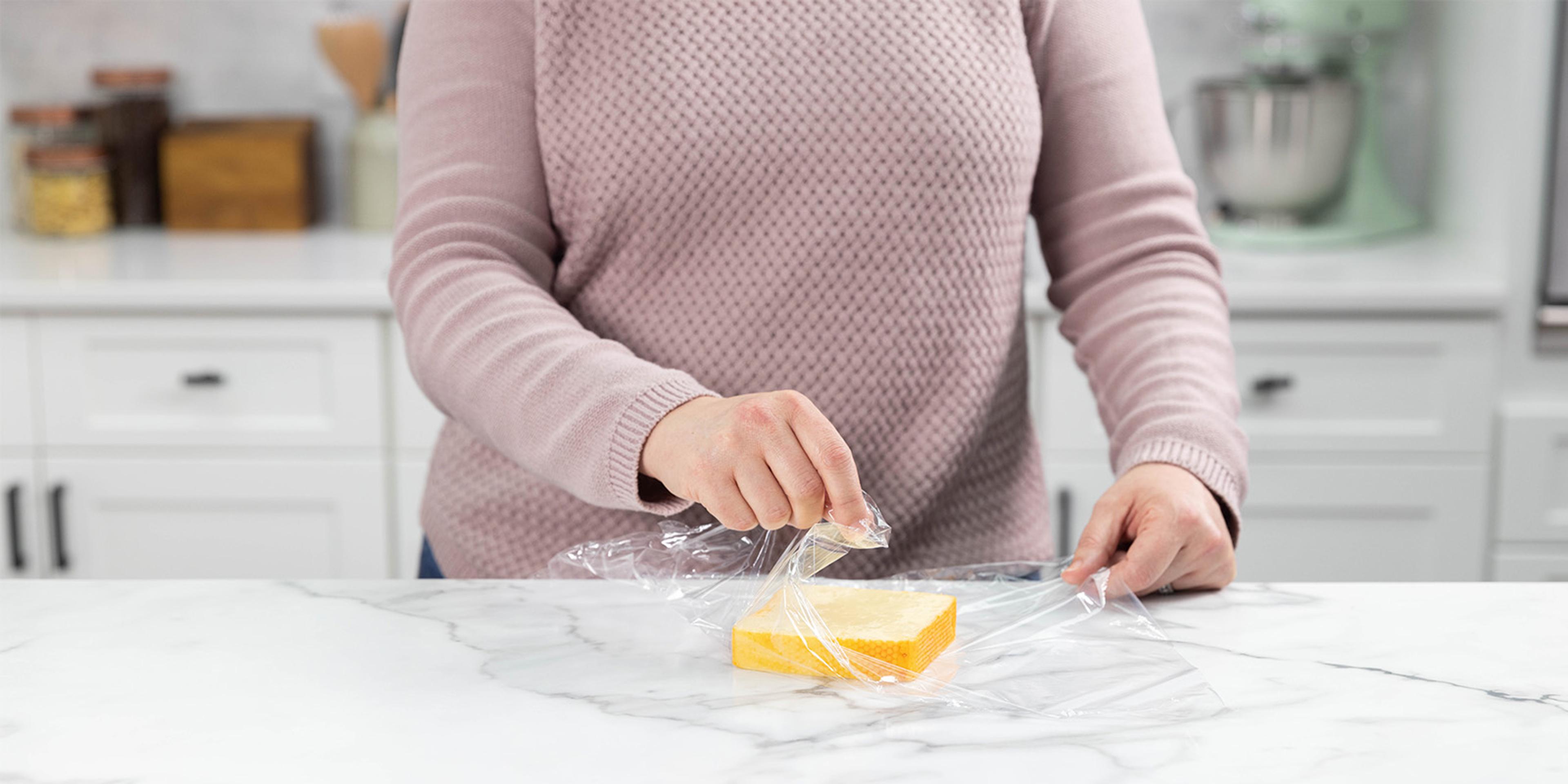 Muenster cheese put in plastic wrap.