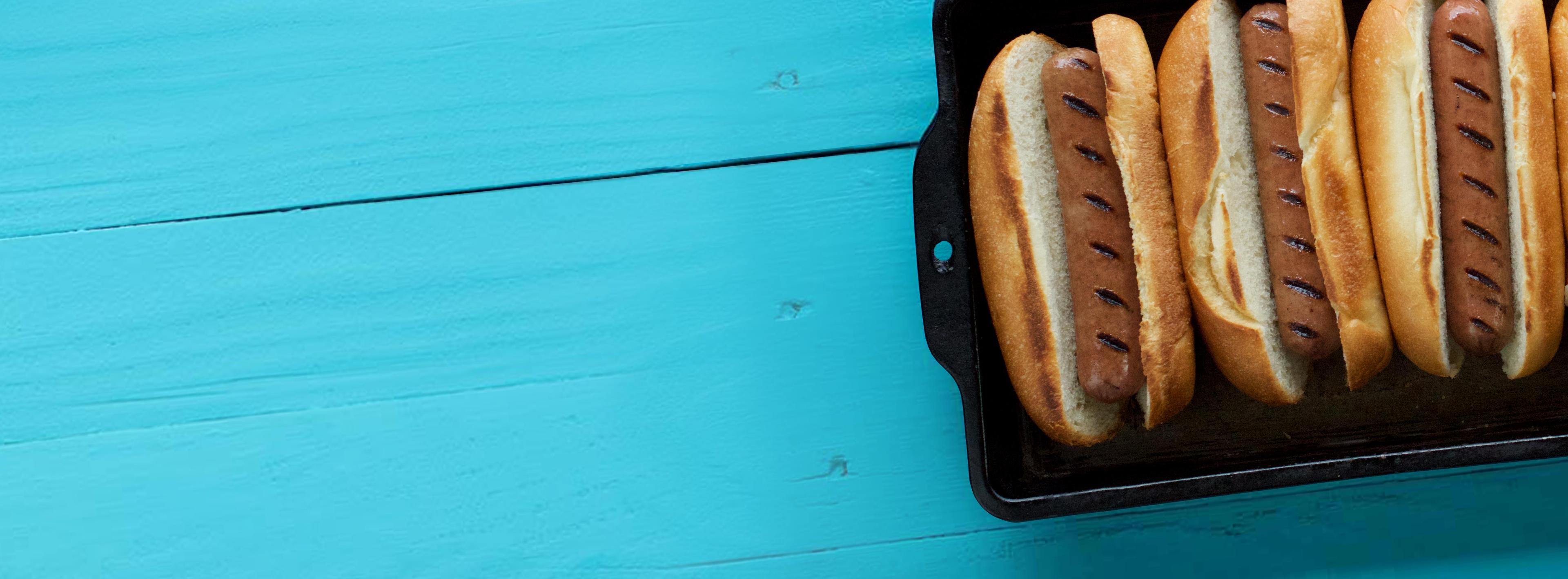 Organic Valley hot dogs in buns on a tabletop