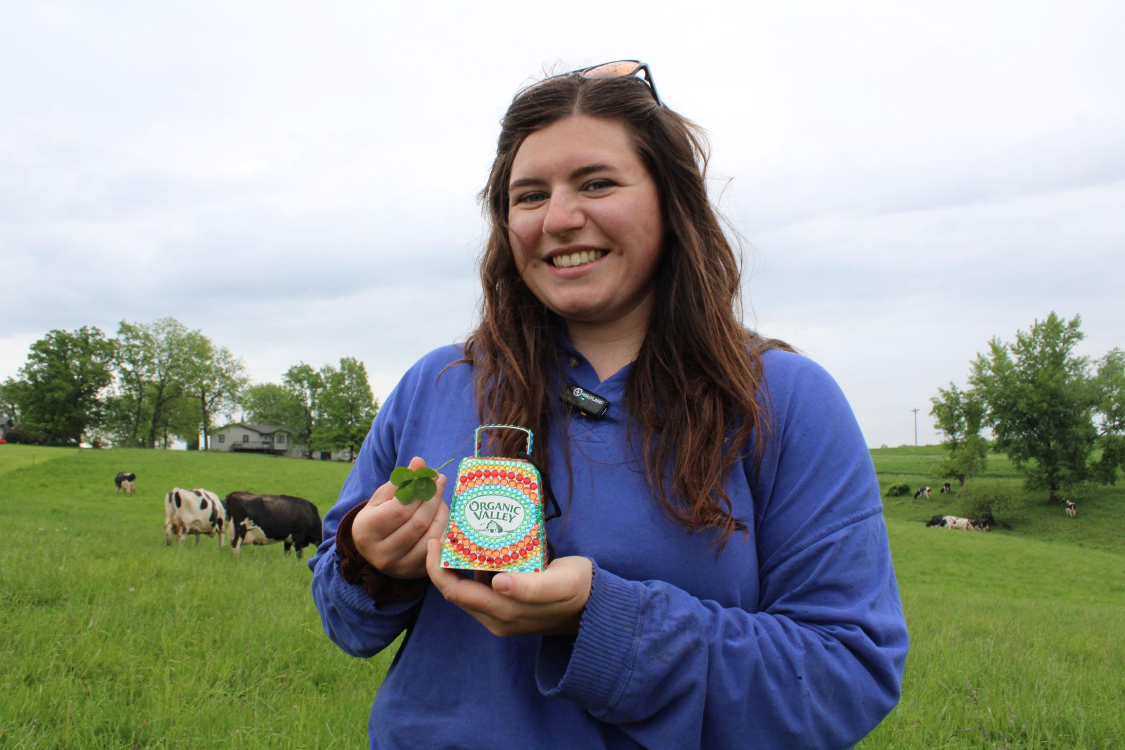 Sabrina Servais with a cow bell and four-leaf clover