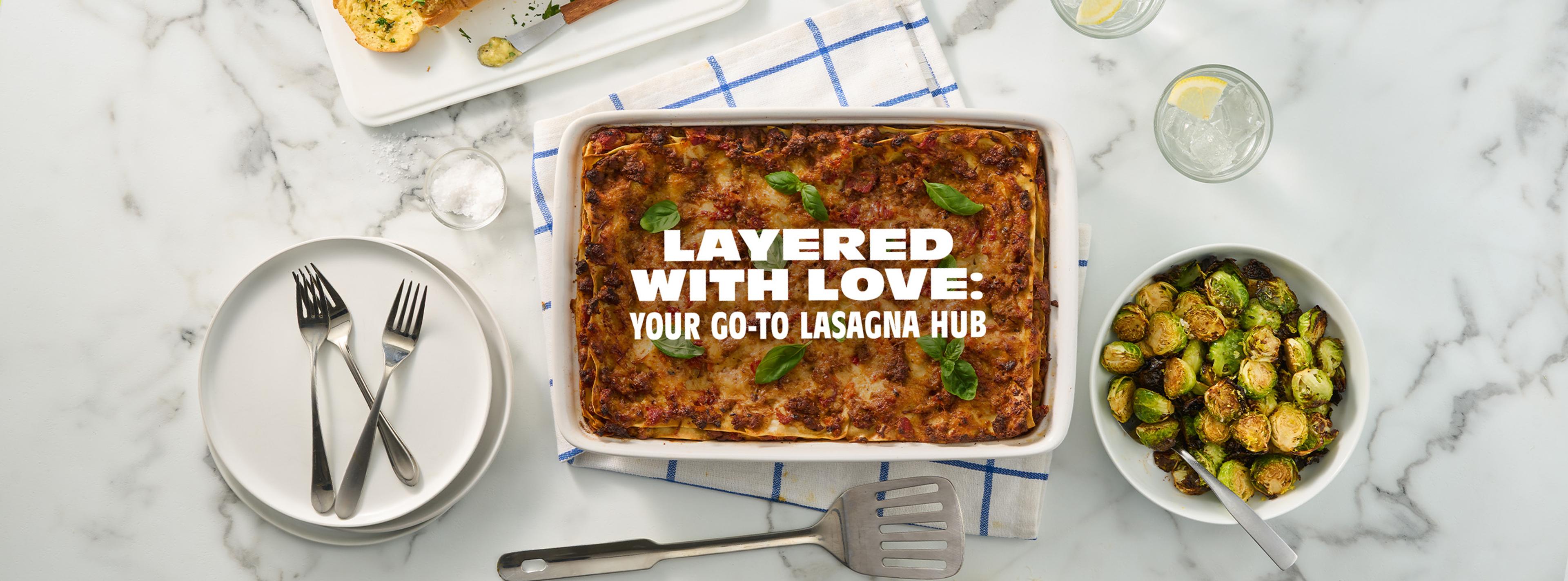 A lasagna with a bowl of Brussel sprouts next to it.