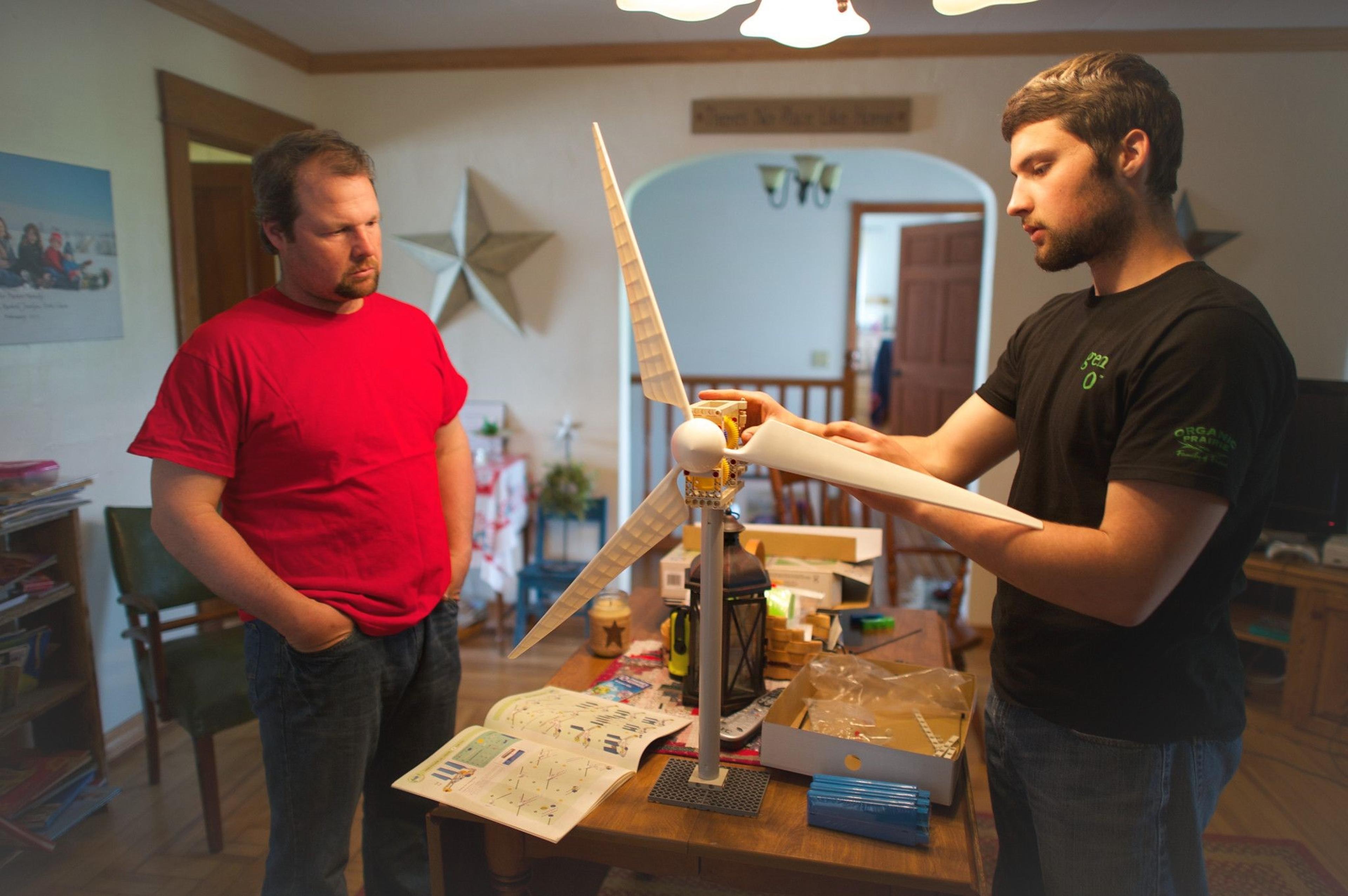 Zane Parker assembles a small windmill as his father looks on.