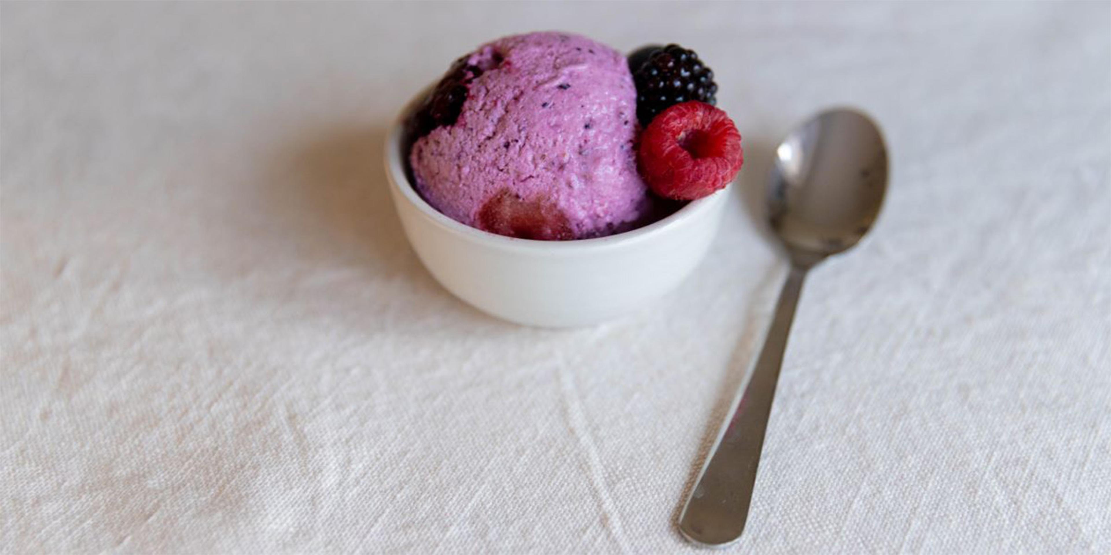 Bountiful Berry Organic Cottage Cheese Ice Cream in a bowl with spoon next to it is ready to eat.