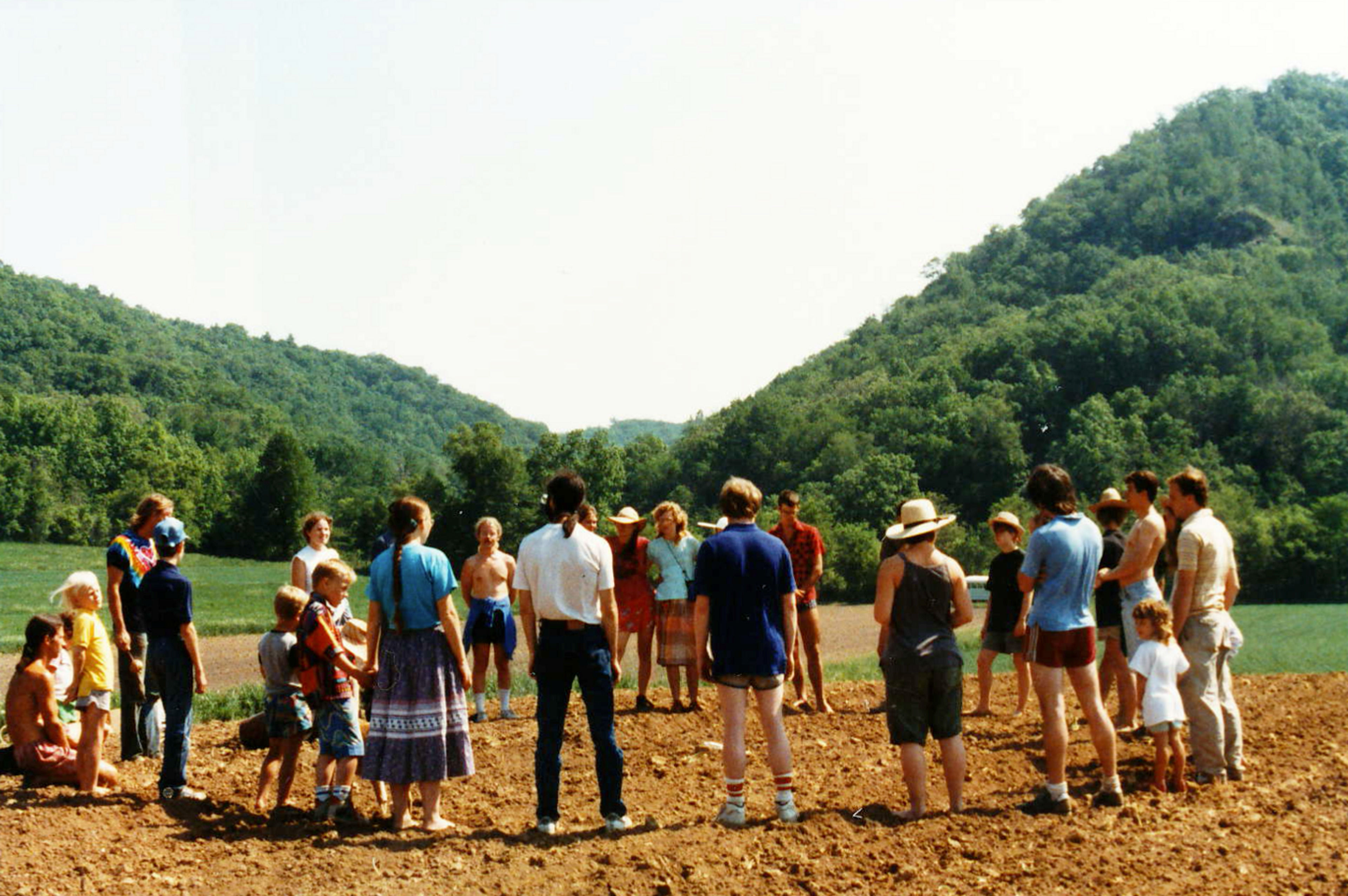 Co-op members at a meeting in a field.