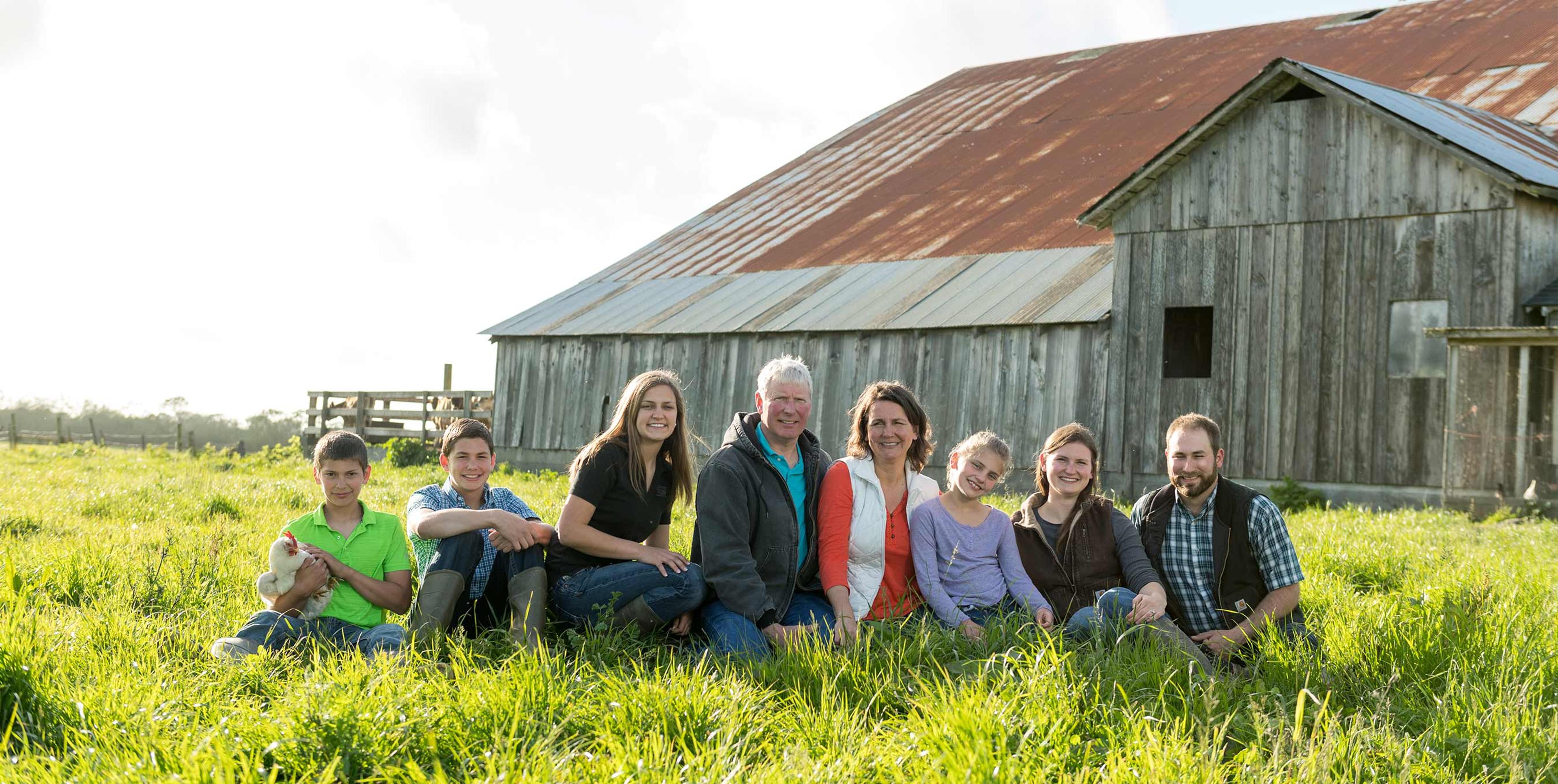 Jim and Susan Regli and family on their organic farm, Regli Jersey Reas Creek.