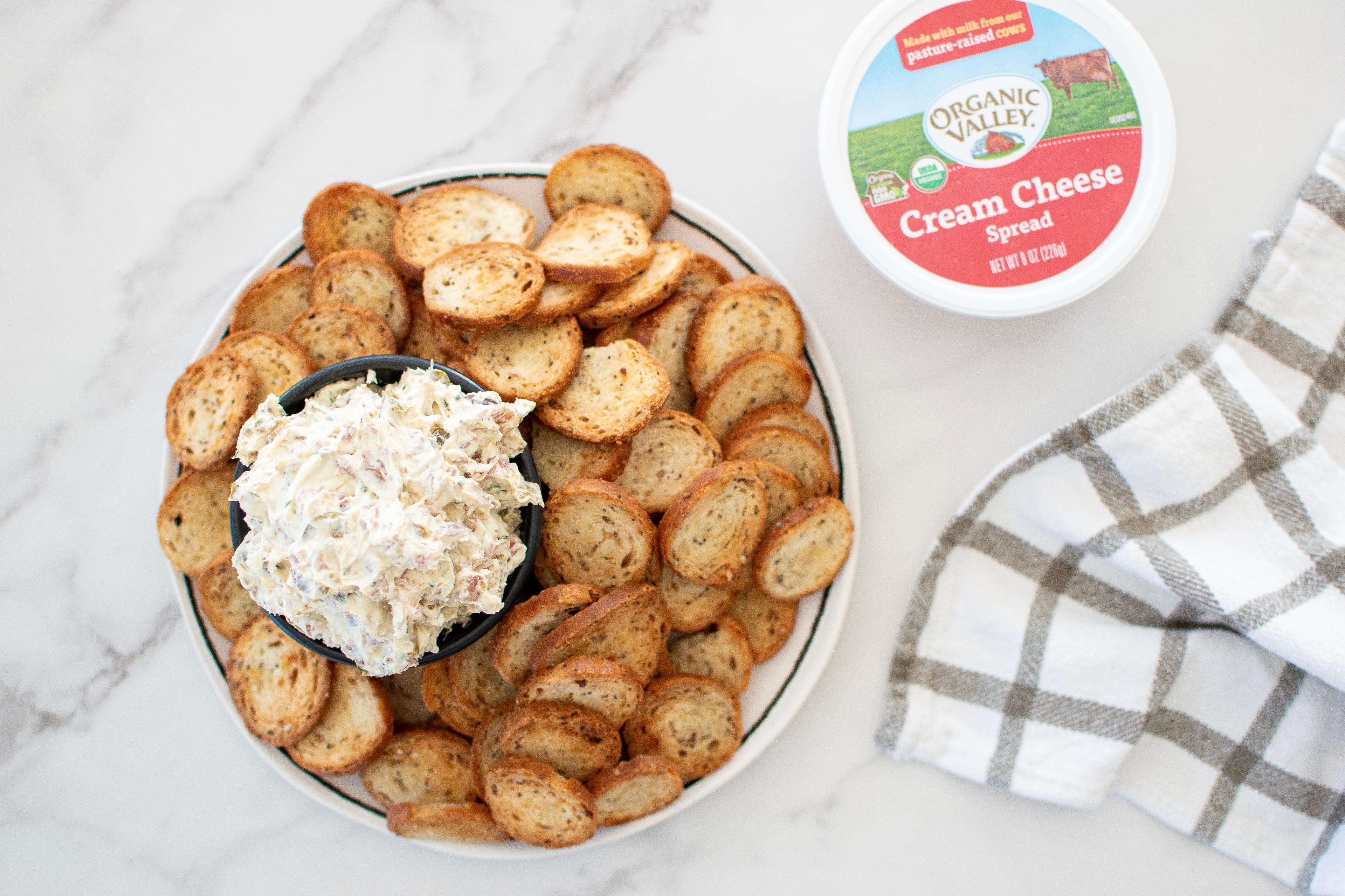 Jalapeño Bacon Cream Cheese Dip on a plate with bagel chips.