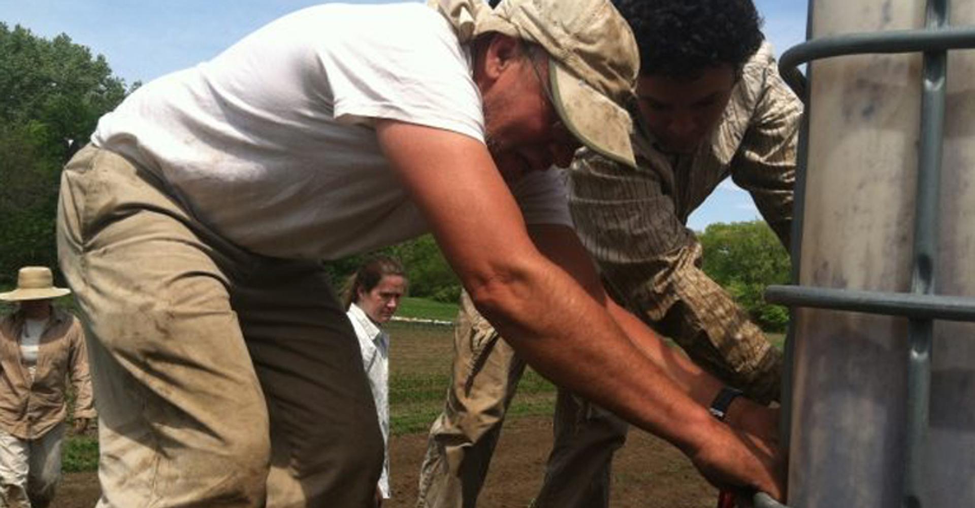 Henry Brockman and his son Kazami bring precious water to the vegetable transplants in early spring.