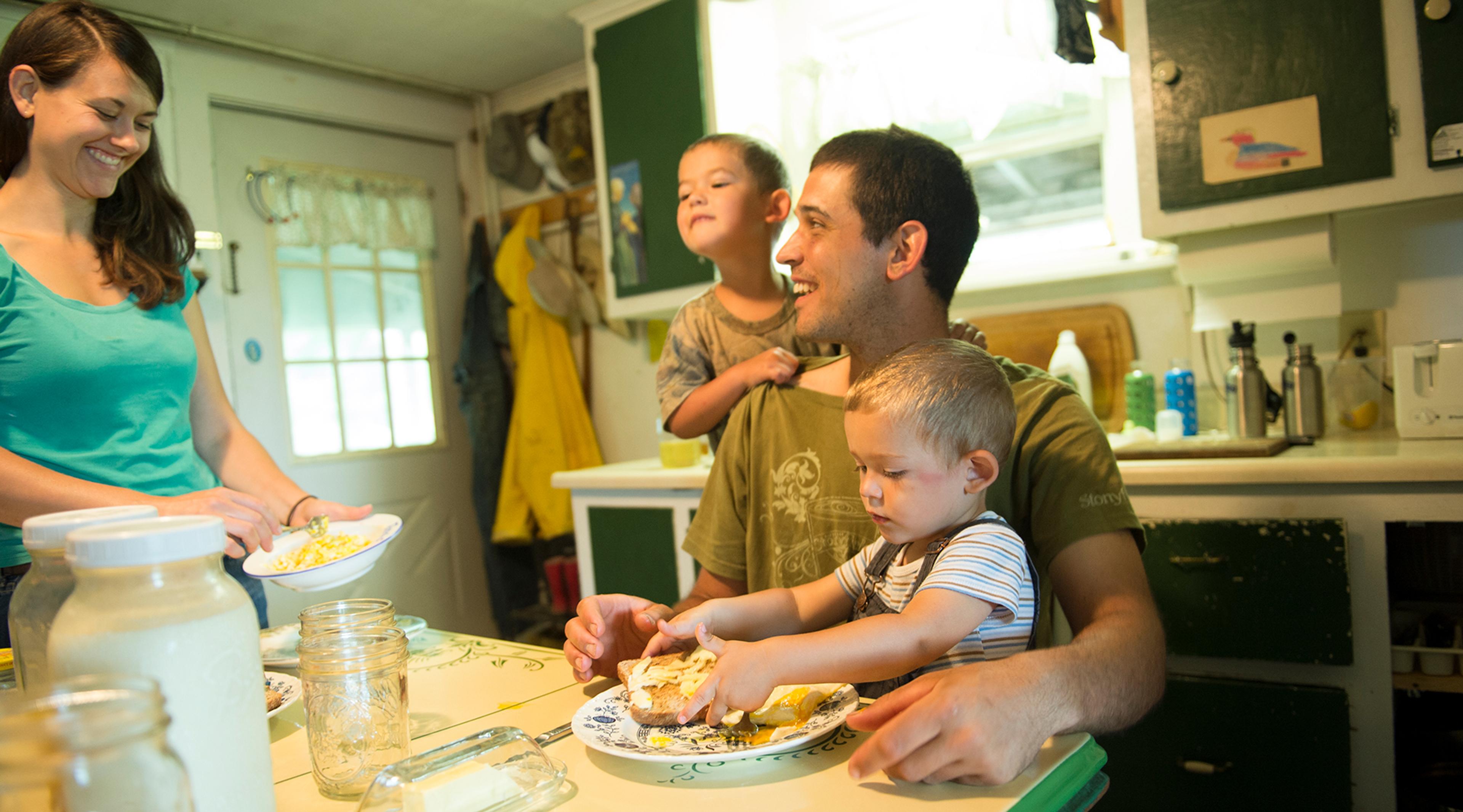 Young family gathered around the kitchen table.
