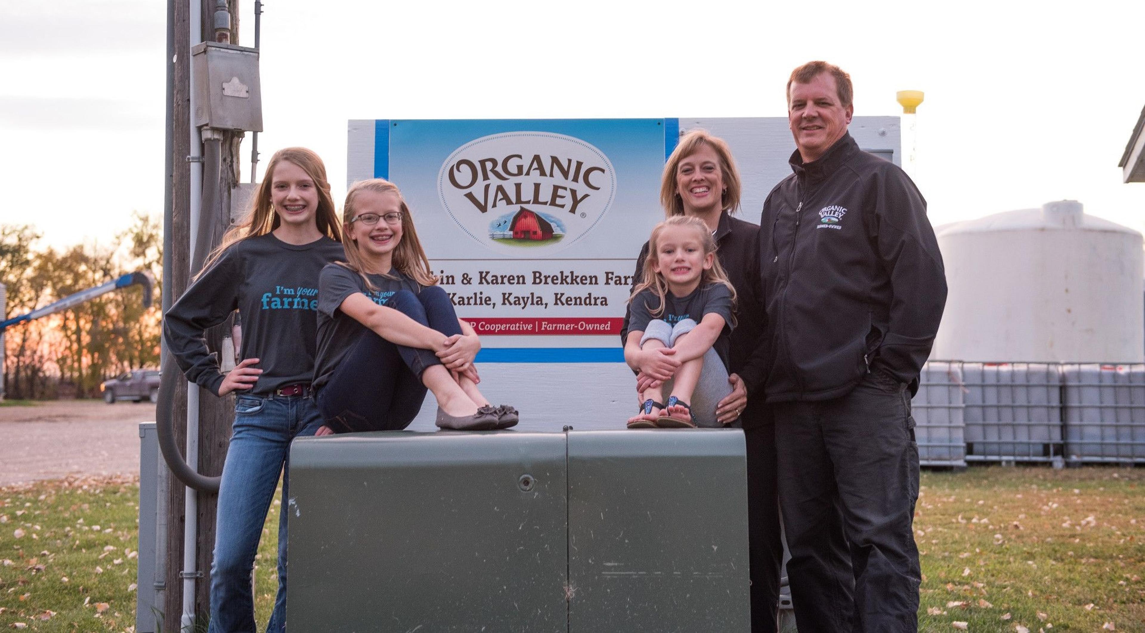 The Brekken family poses by an Organic Valley sign. Spring planting has begun in the Midwest.