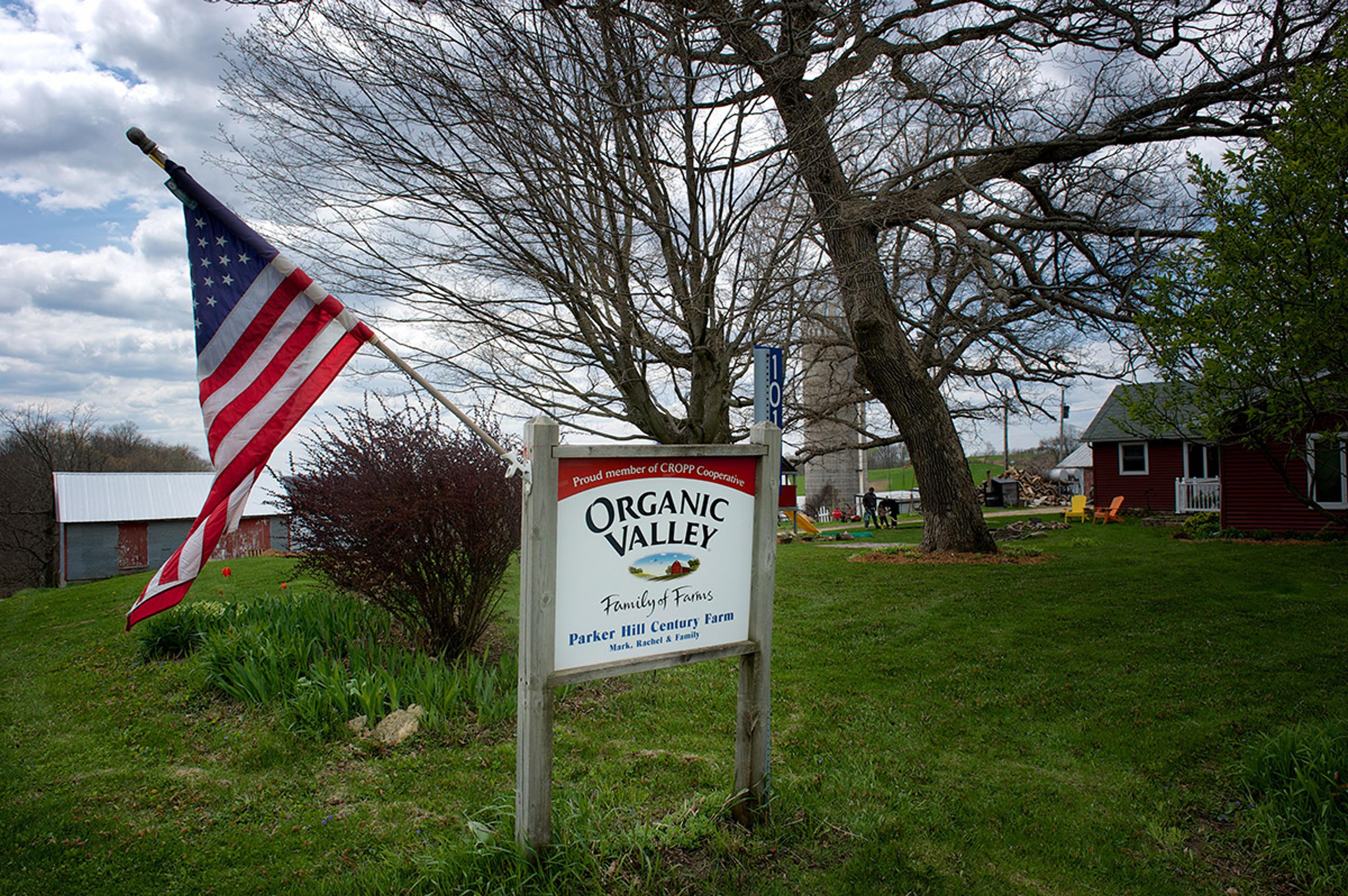 An Organic Valley sign and American flag are hung in the yard at the Parker farm in Wisconsin.