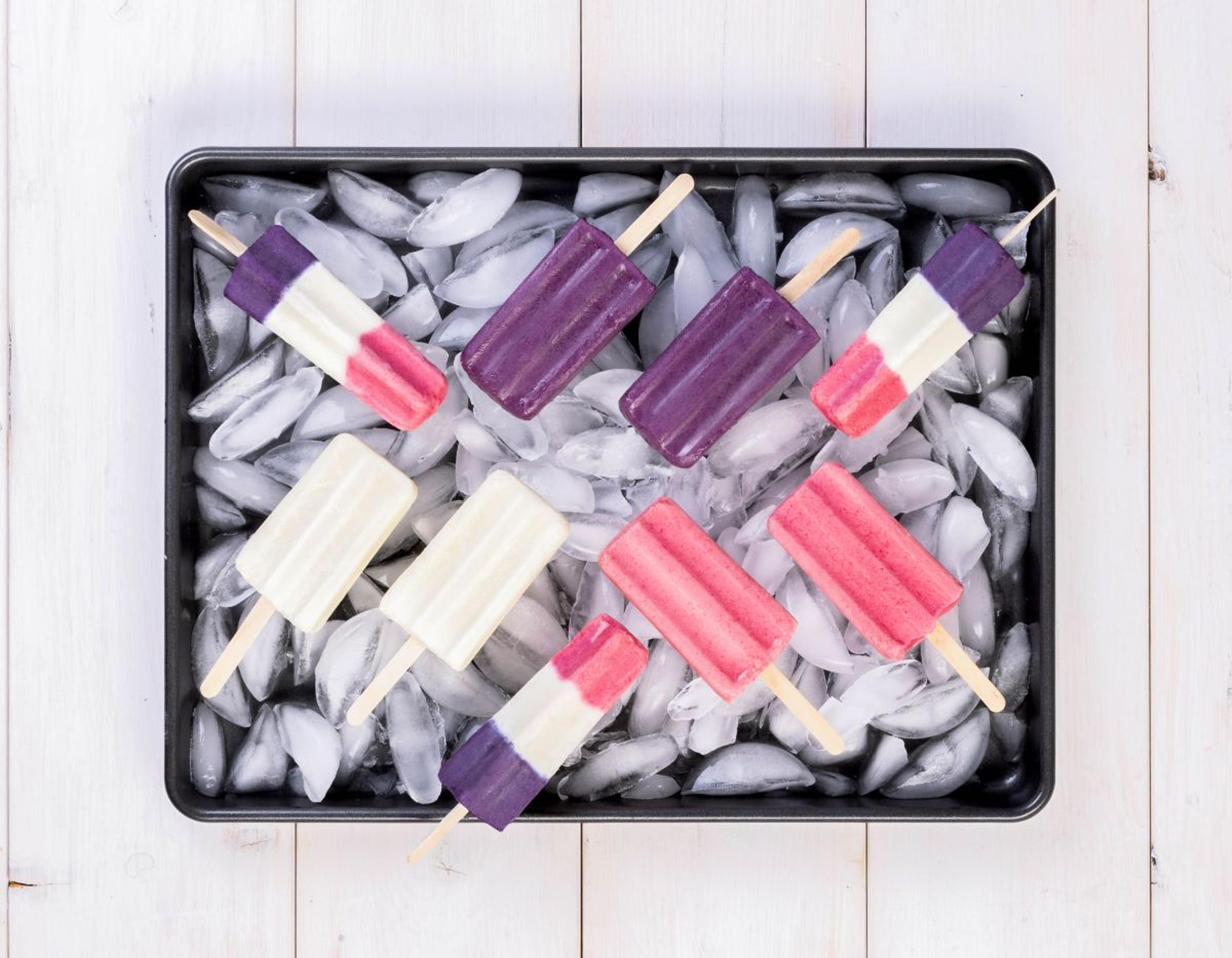 Red, white and blue popsicles in a pan of ice